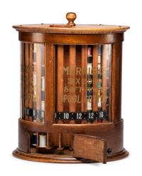 A Merrick's Six Cord Cylindrical Oak Spool Cabinet