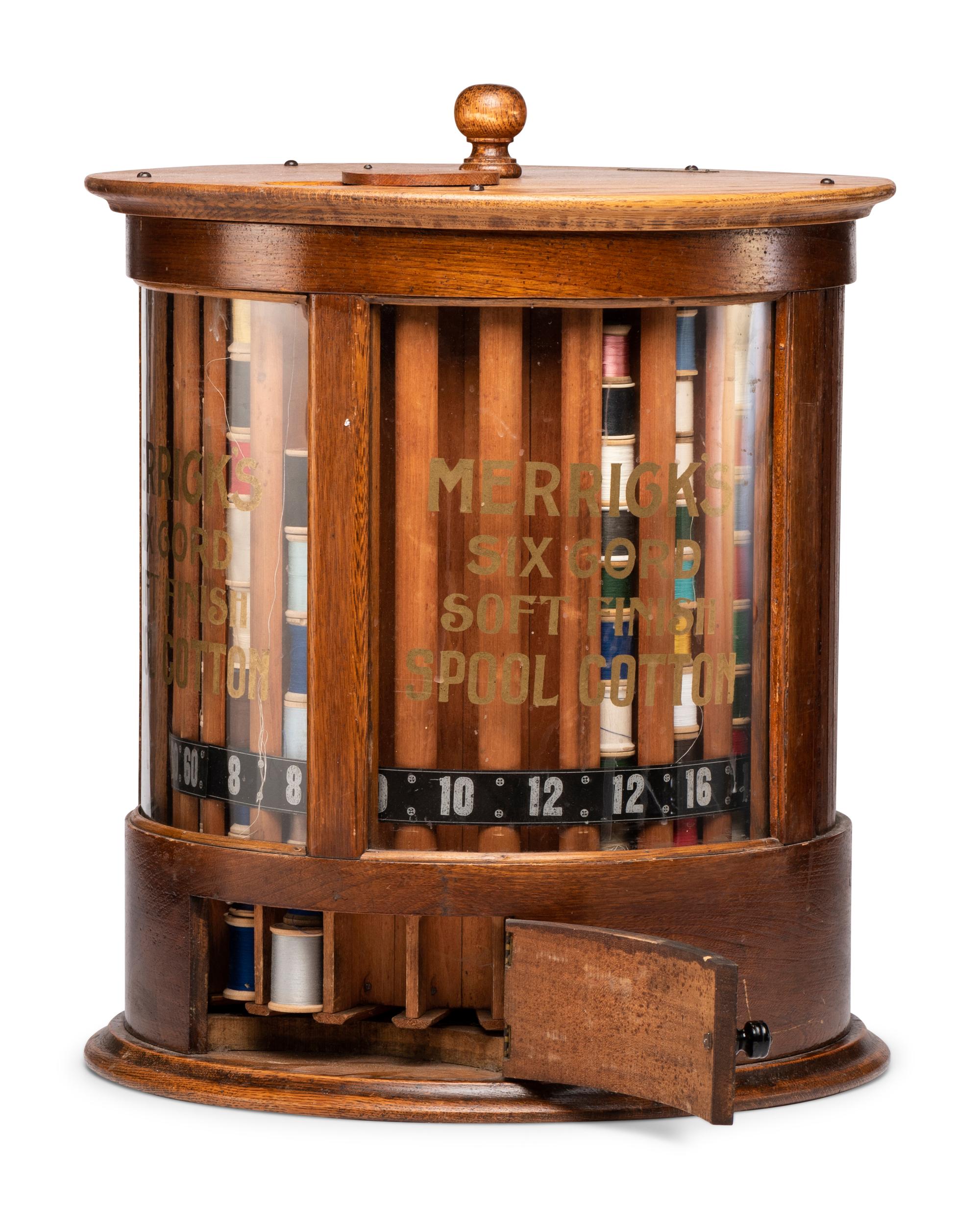 A Merrick's Six Cord Cylindrical Oak Spool Cabinet