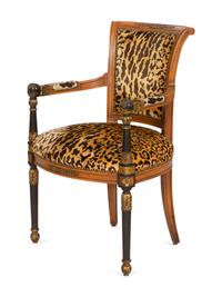 A Directoire Style Ebonized and Parcel Gilt Walnut Fauteuil