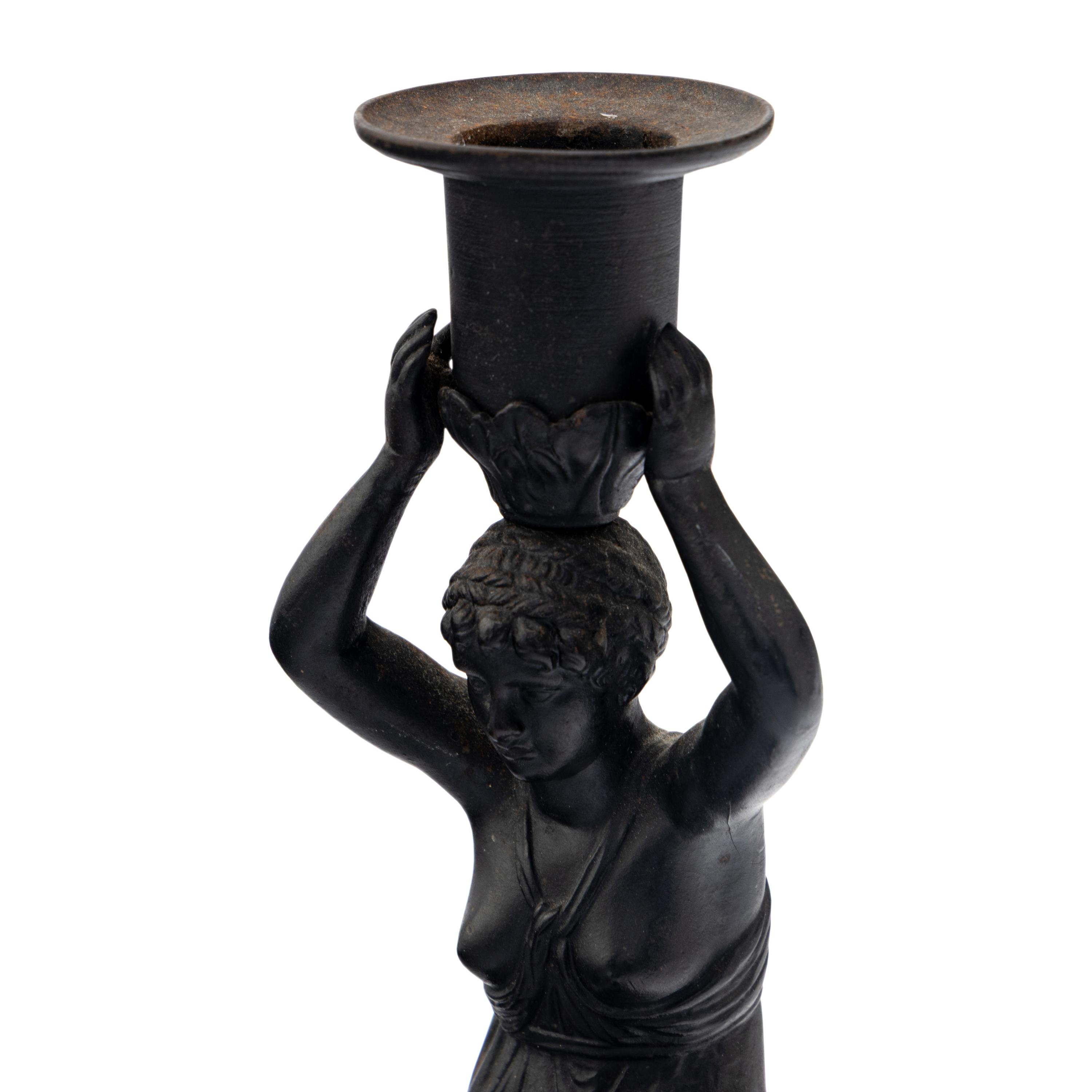 A Pair of Grand Tour Patinated Metal Figural Candlesticks