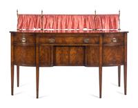 A Regency Style Mahogany Sideboard with Silk Drape on a Brass Gallery