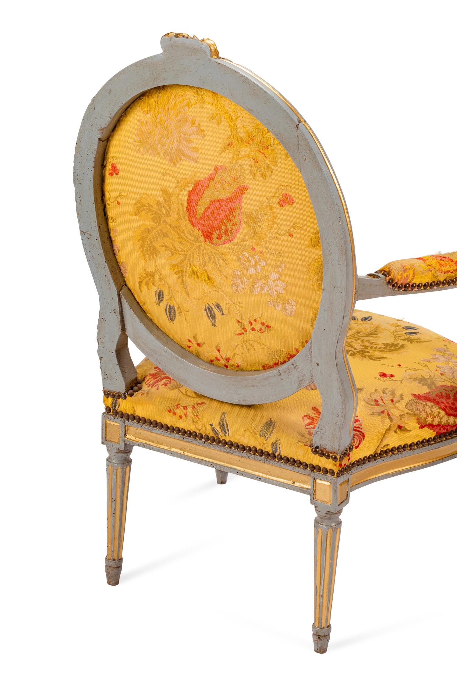 A Pair of Louis XVI Painted and Parcel Gilt Fauteuils