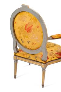 A Pair of Louis XVI Painted and Parcel Gilt Fauteuils