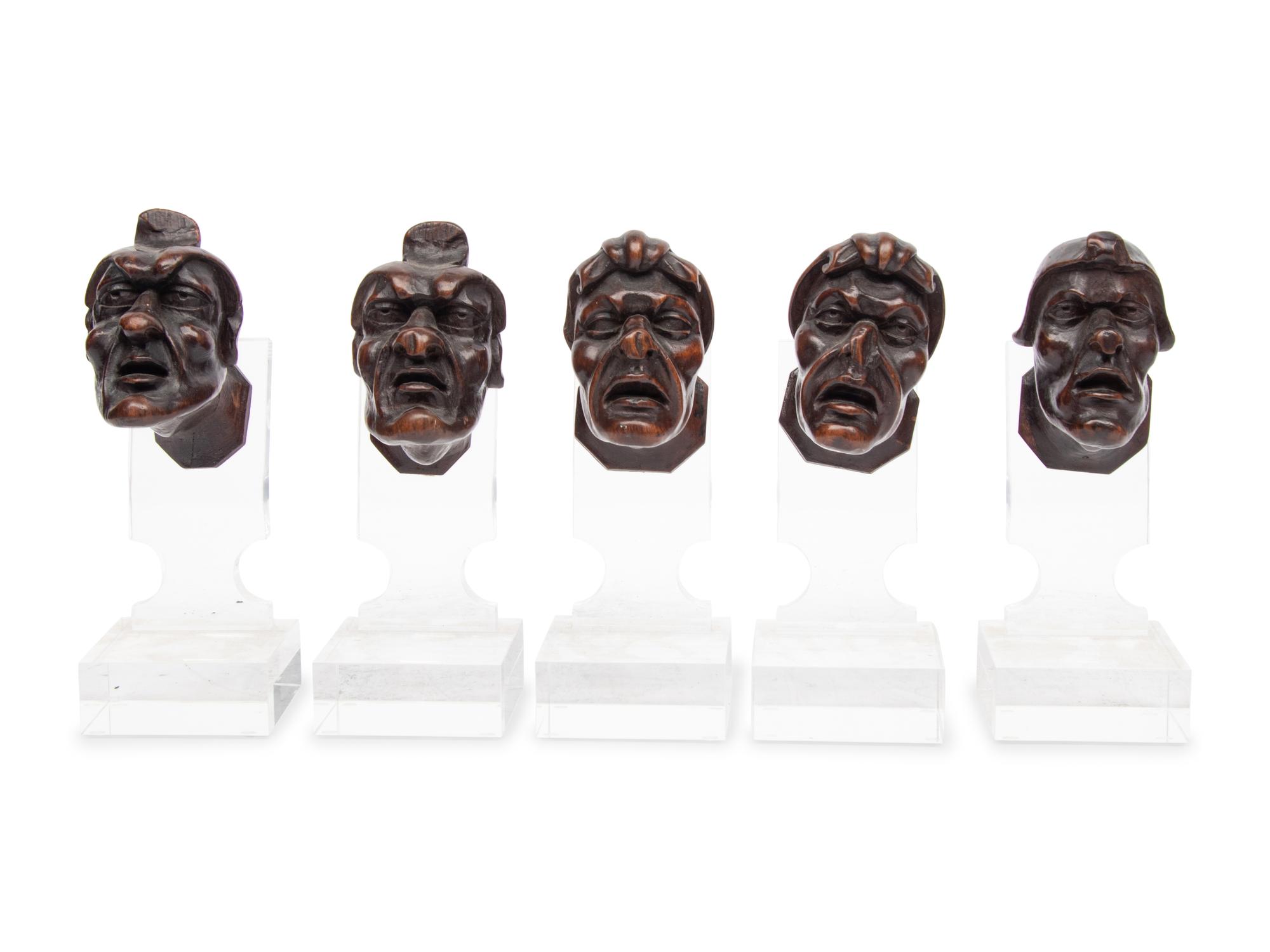 A Set of Five Italian Baroque Carved Walnut Heads of Grotesques