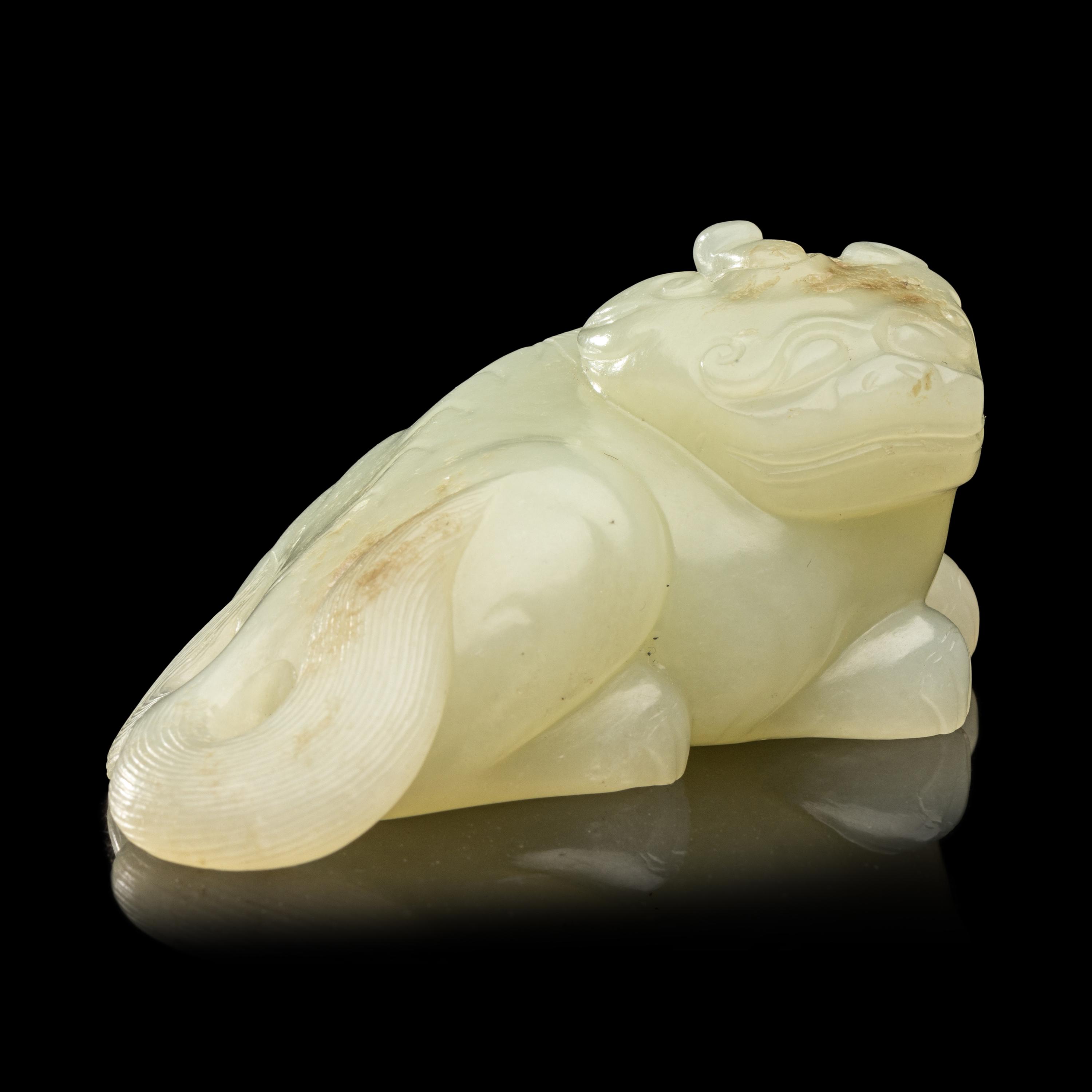 A Chinese Pale Celadon Jade Figure of a Mythical Beast, Early Qing Dynasty 清早期 青白玉瑞獸