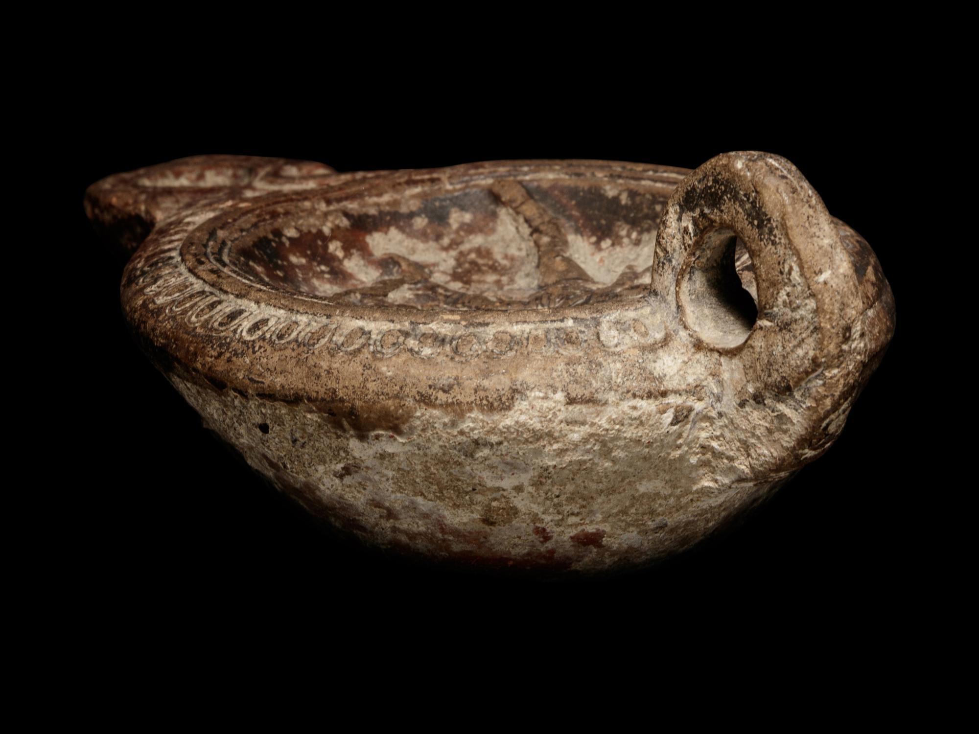 A Roman Terracotta Oil Lamp with Gladiators
