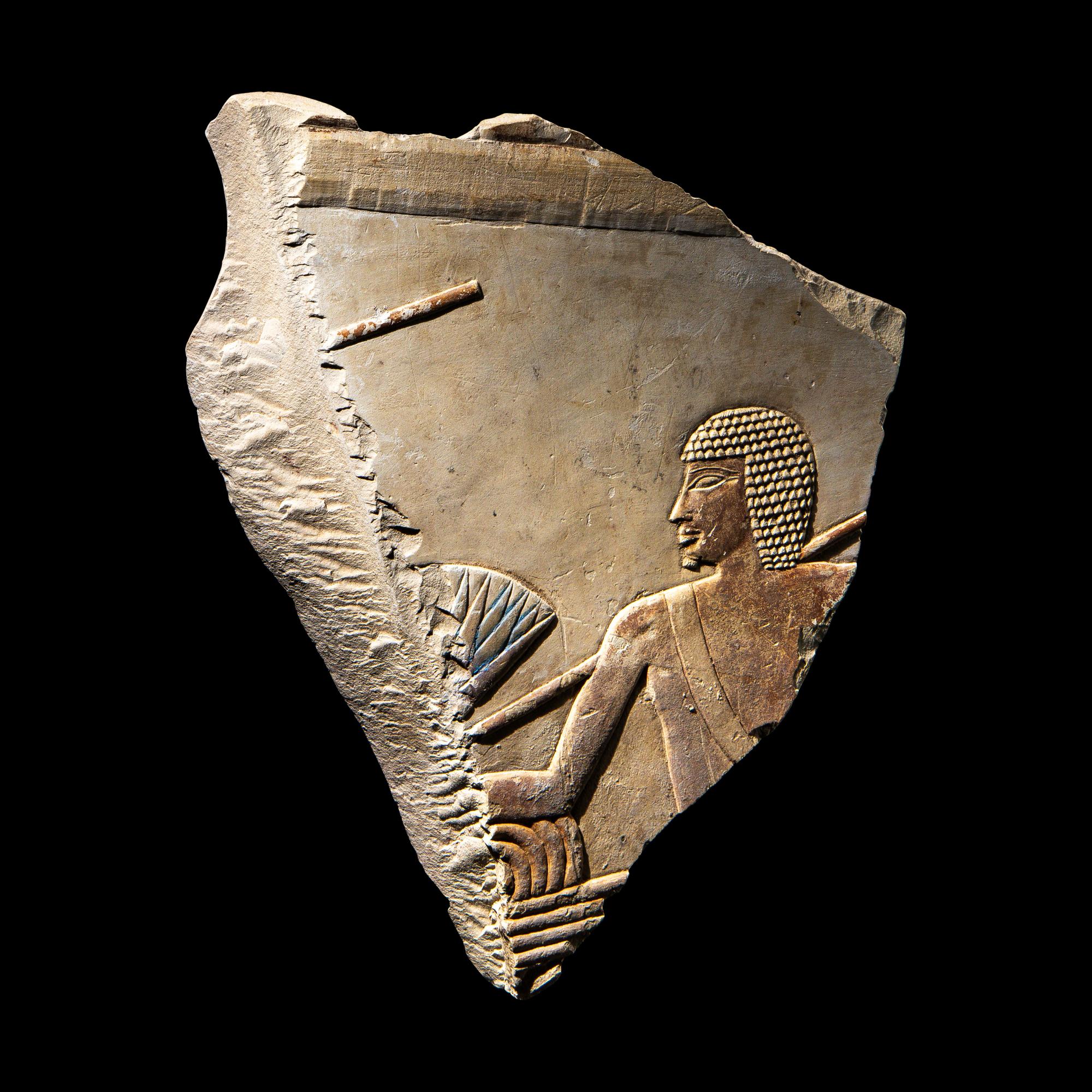 An Egyptian Painted Limestone Relief Fragment