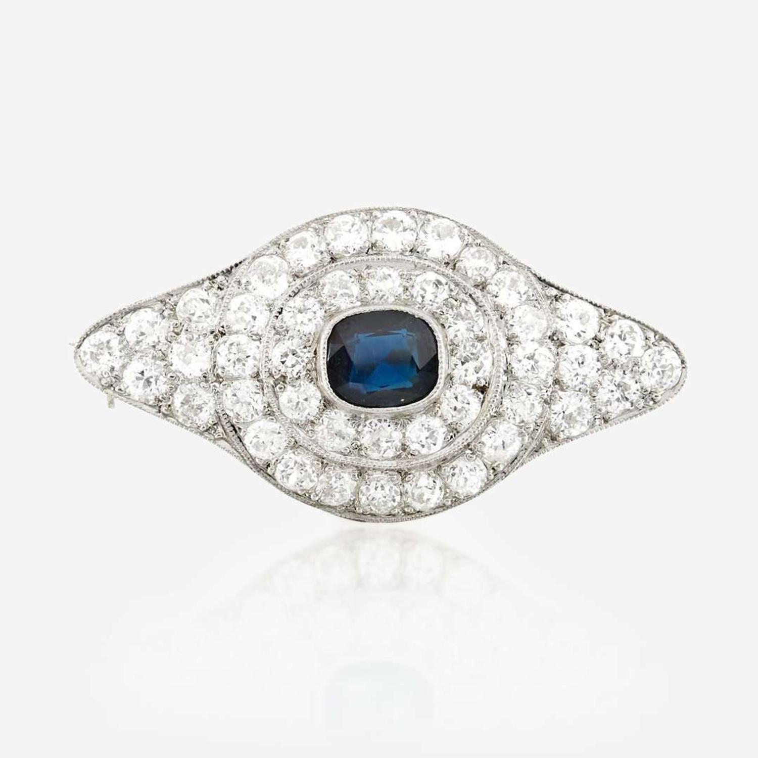 A sapphire, diamond, platinum, and white metal brooch
