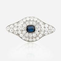 A sapphire, diamond, platinum, and white metal brooch
