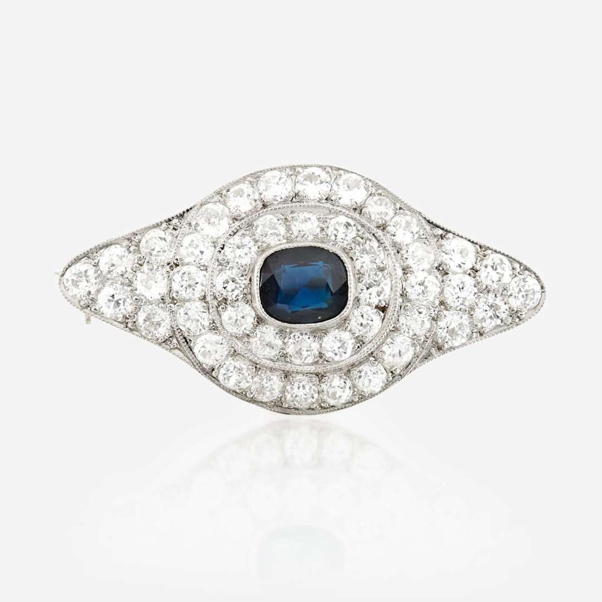 A sapphire, diamond, platinum, and white metal brooch