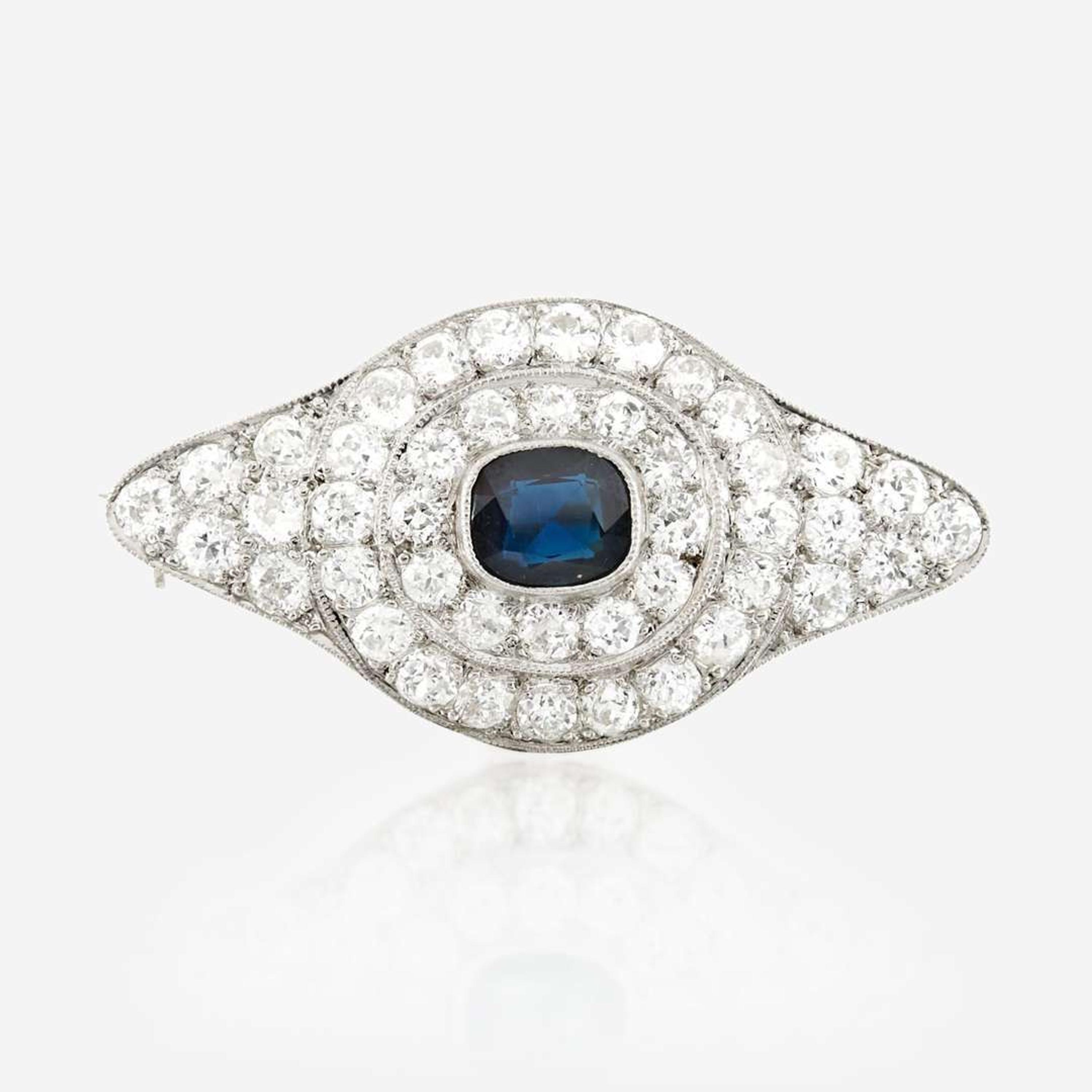 A sapphire, diamond, platinum, and white metal brooch