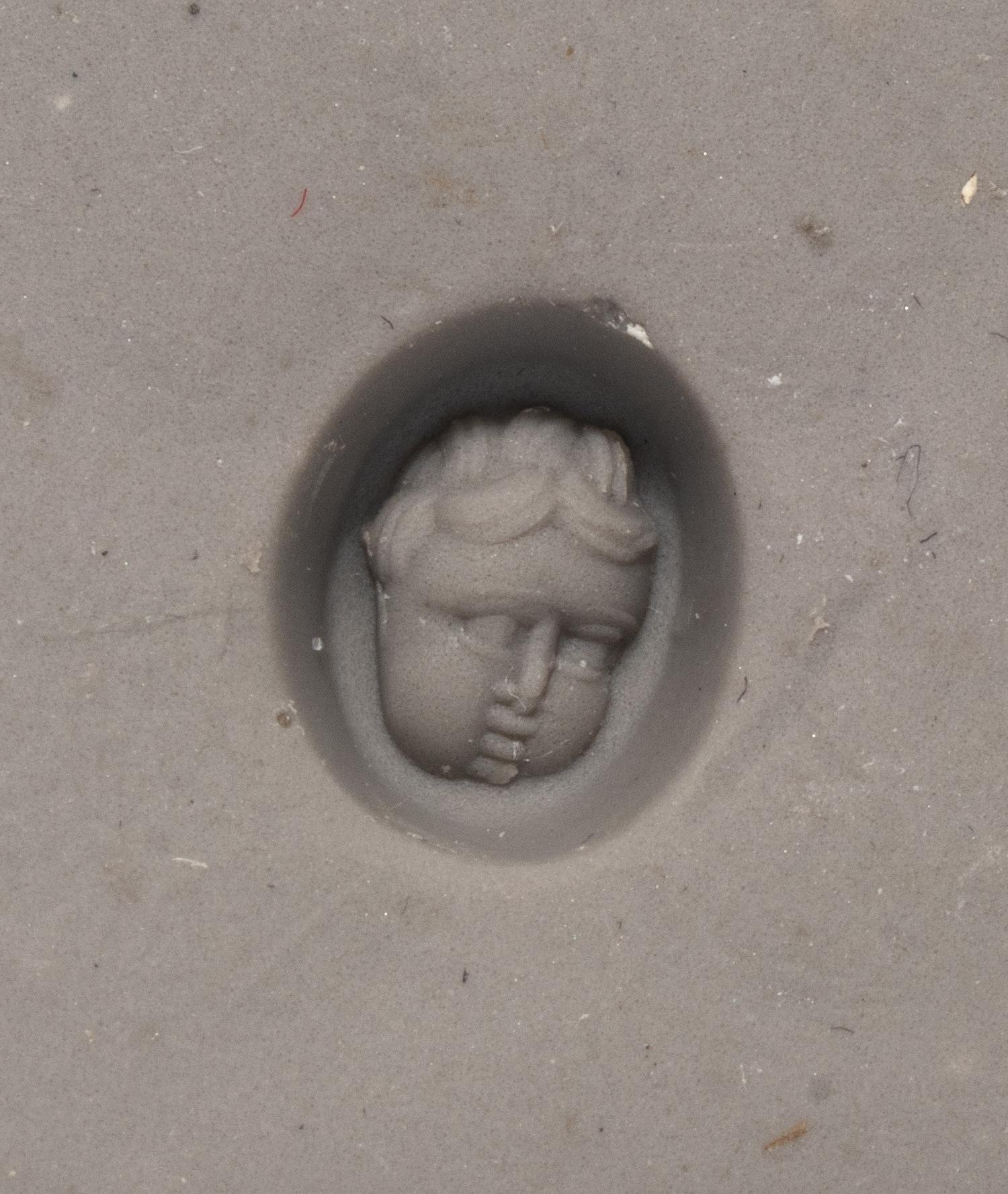 A Roman Red Jasper Ring Stone with the Head of a Baby