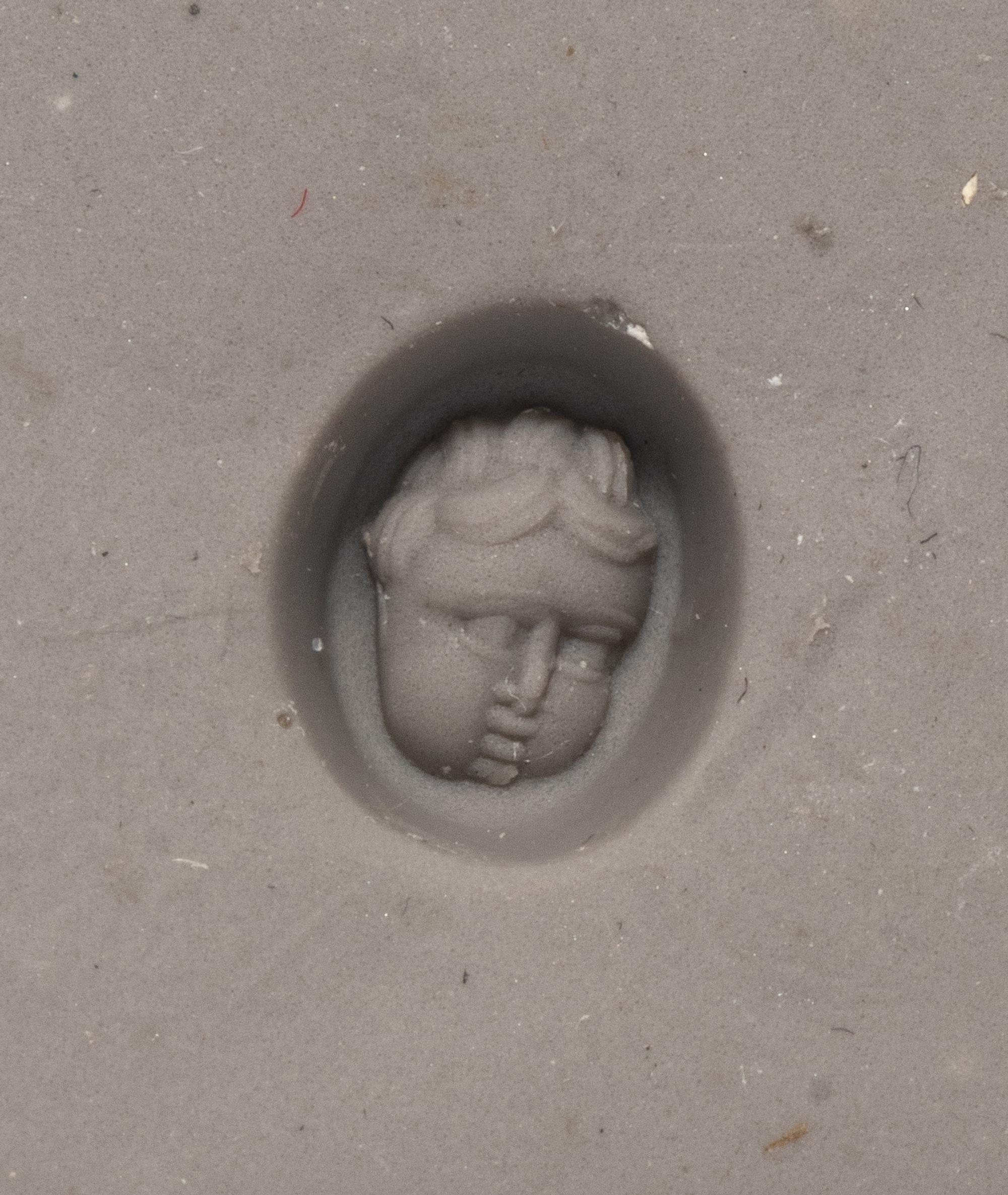 A Roman Red Jasper Ring Stone with the Head of a Baby