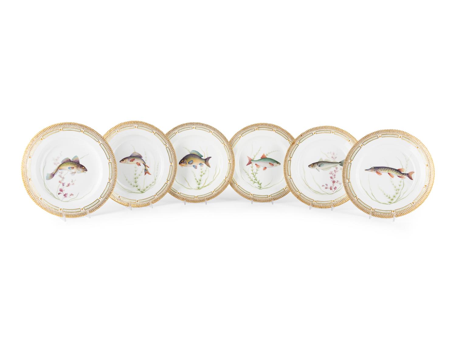 A Set of Twelve Royal Copenhagen Parcel Gilt Porcelain Fish Plates
