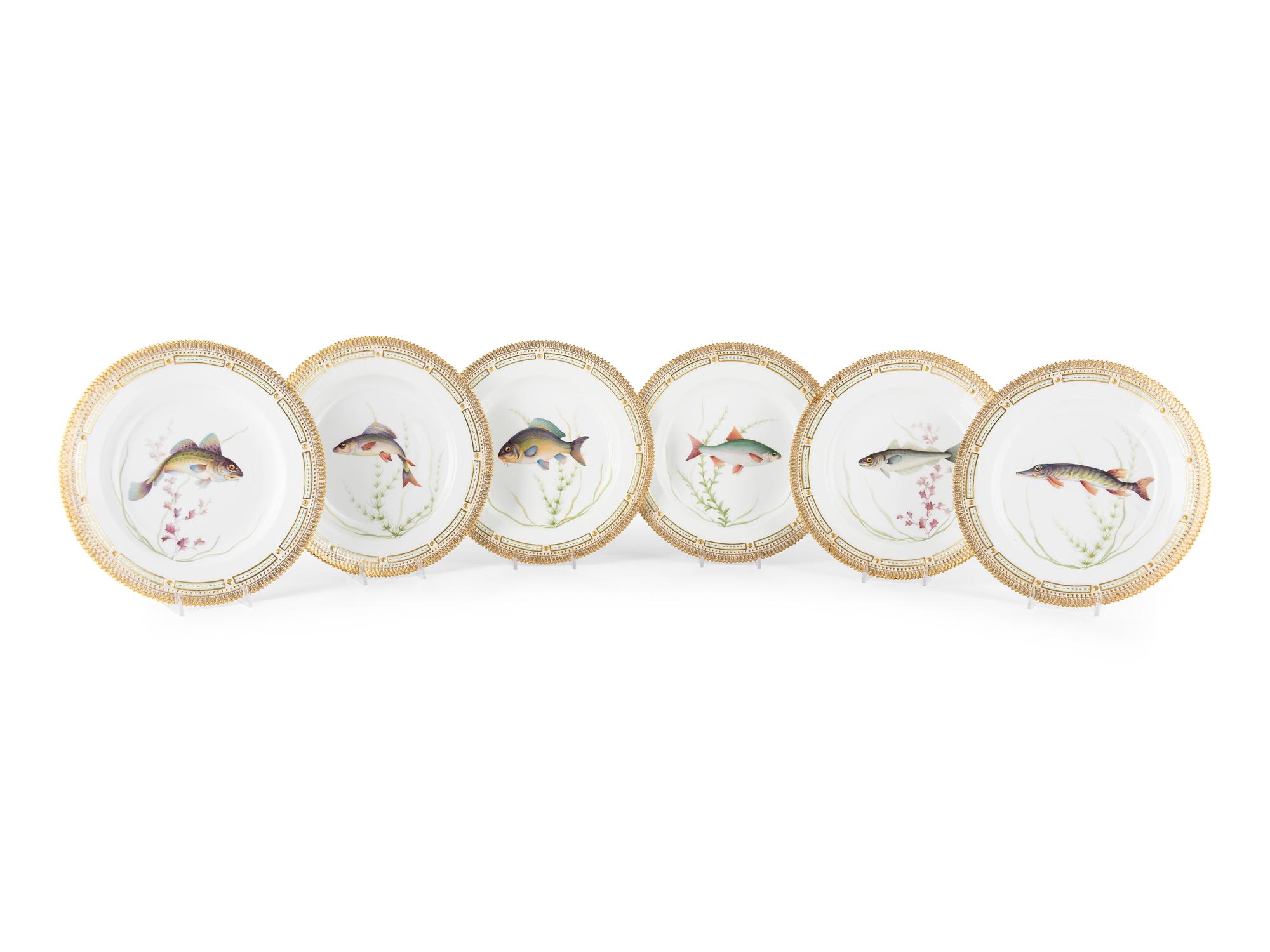 A Set of Twelve Royal Copenhagen Parcel Gilt Porcelain Fish Plates