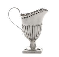 A Victorian Silver Creamer, Hilliard & Thomason, Birmingham, 1892, the lower half of the body ribbed, raised on a square foot.