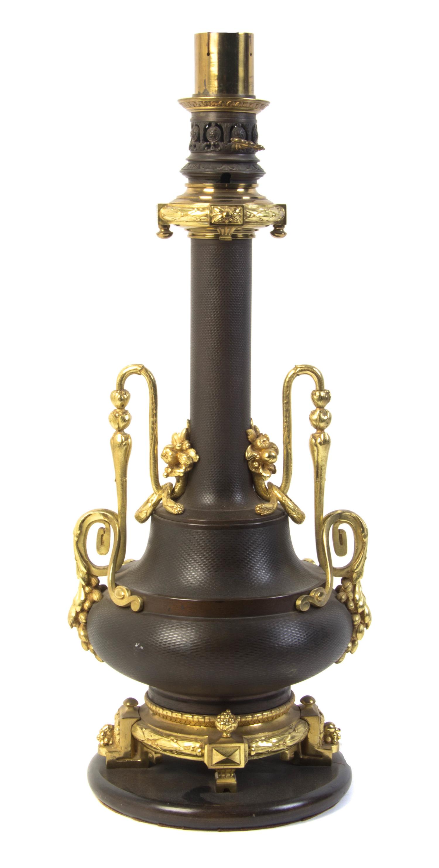 A French Gilt and Patinated Bronze Table Lamp, Height overall 37 inches.