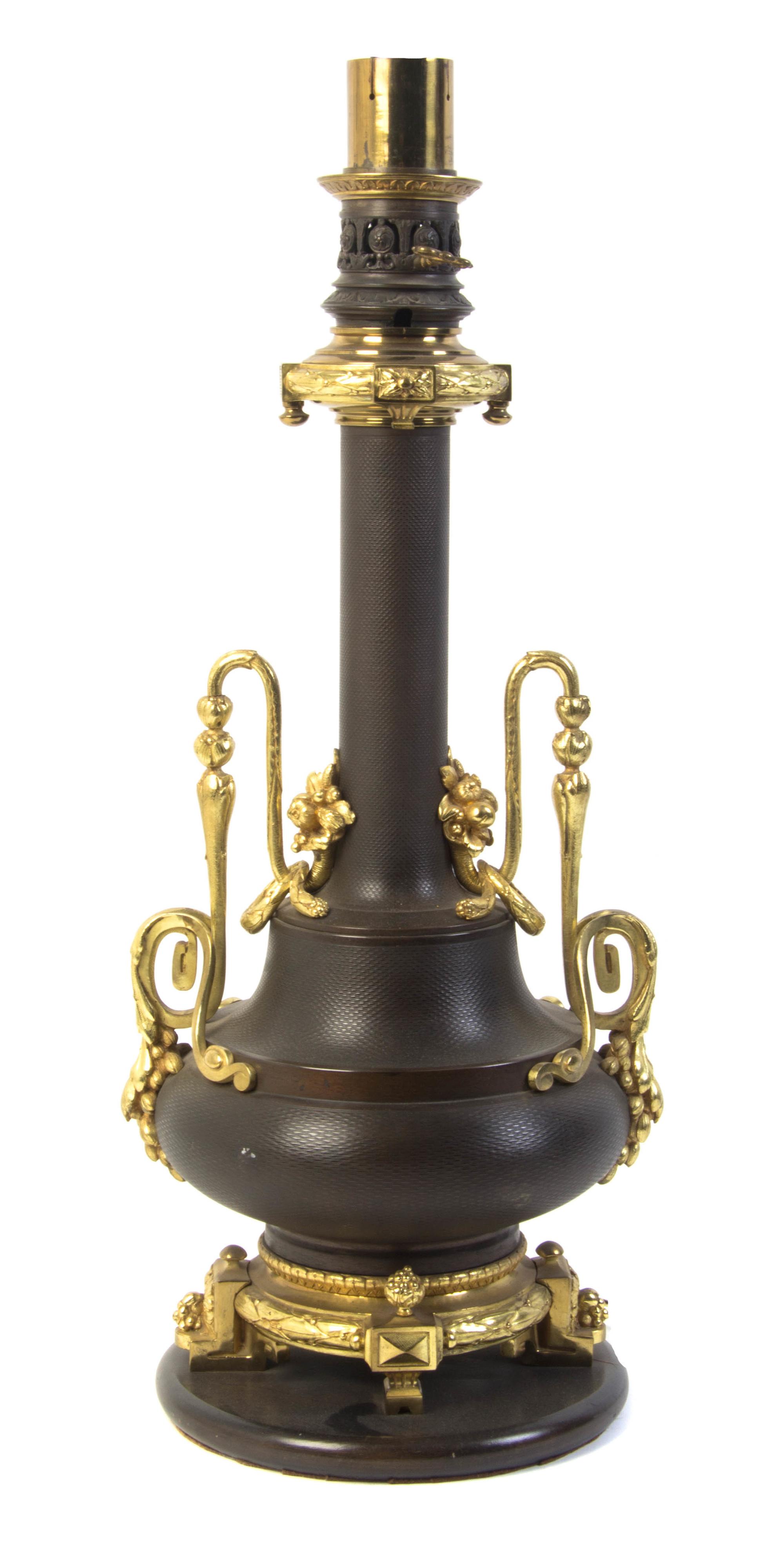 A French Gilt and Patinated Bronze Table Lamp, Height overall 37 inches.