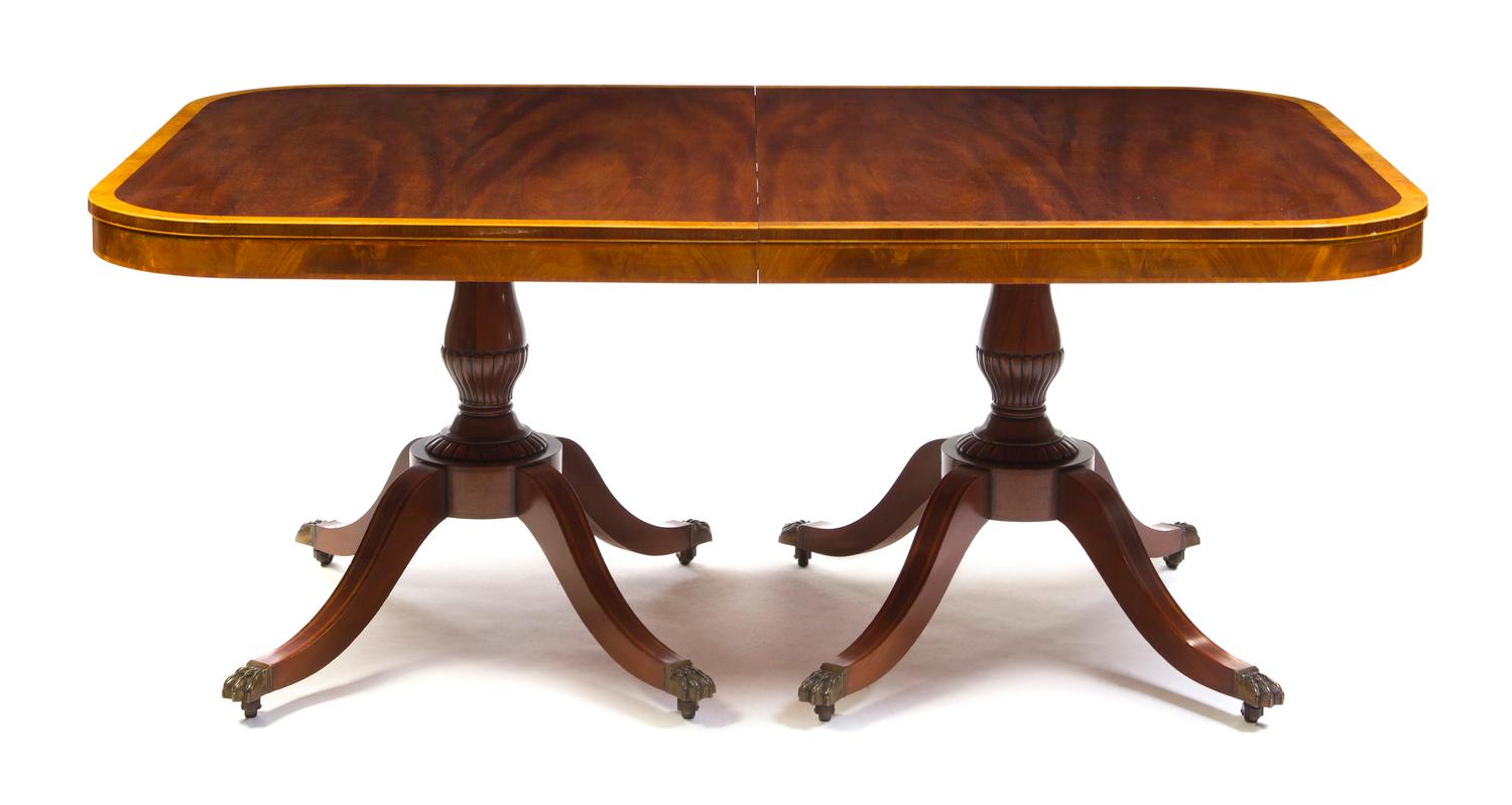 A George III Style Mahogany Double Pedestal Table, Height 29 1/2 x width 96 x depth 48 inches (with two leaves included).