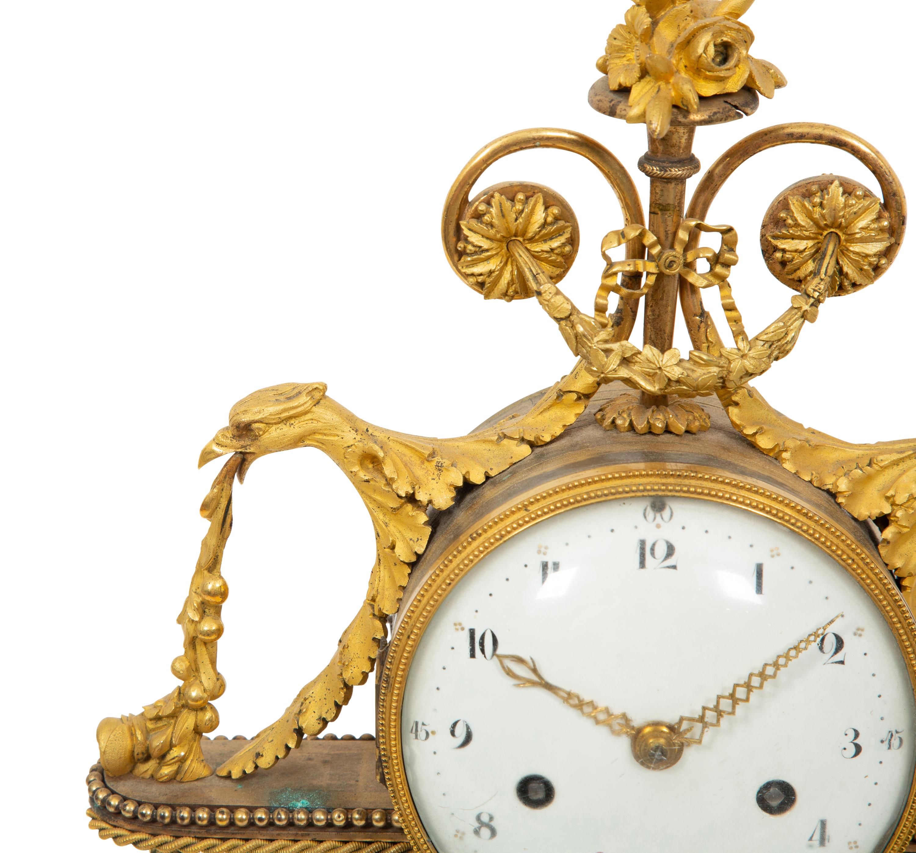 A Louis XVI Gilt Bronze and Marble Mantel Clock