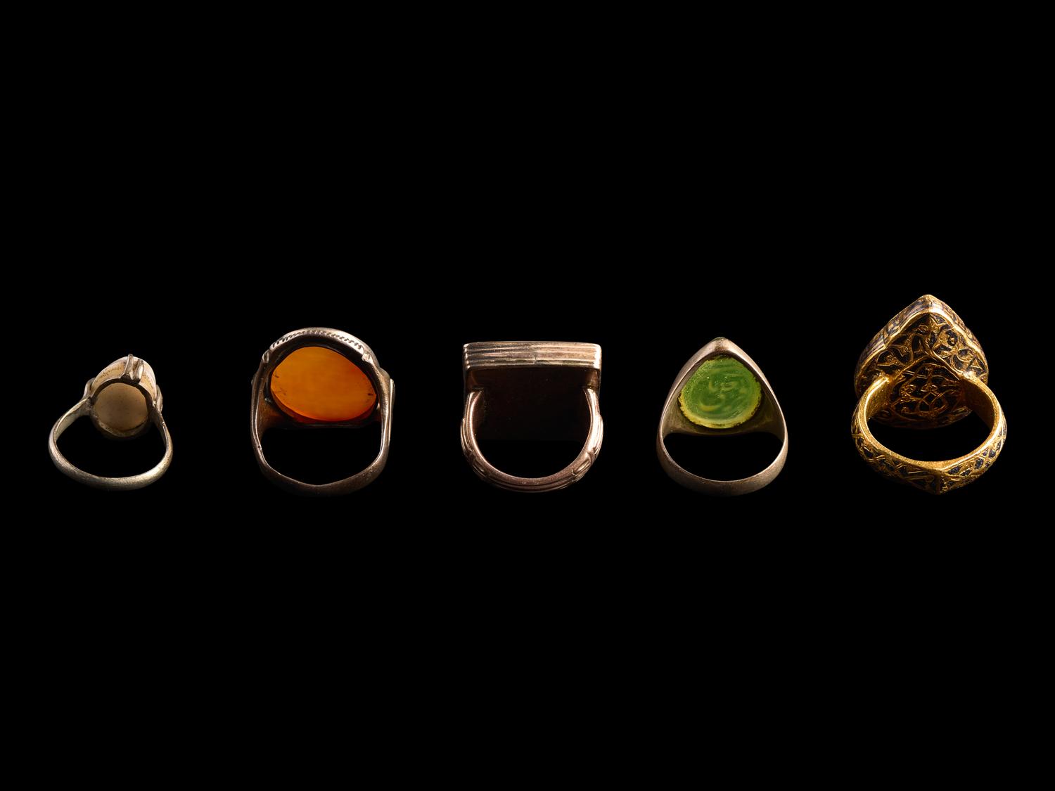 A Group of Five Islamic Stone and Metal Finger Rings