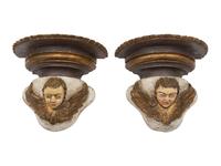 A Pair of Continental Baroque Style Polychromed Putto Mask Wall Brackets