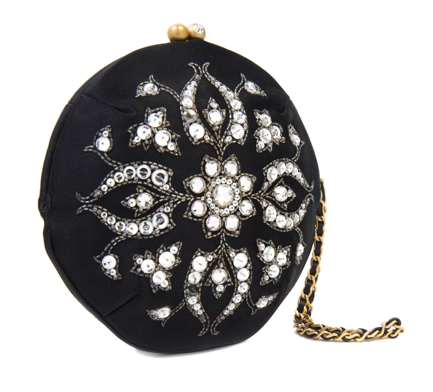 A Chanel Black Silk Embroidered Rhinestone Circular Clutch, 7" diameter.