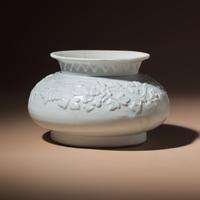 A Chinese White Glazed Molded Porcelain 'Floral' Jar, Mid Ming Dynasty, 15th Century — 明中期 白釉模印纏枝花卉敞口罐