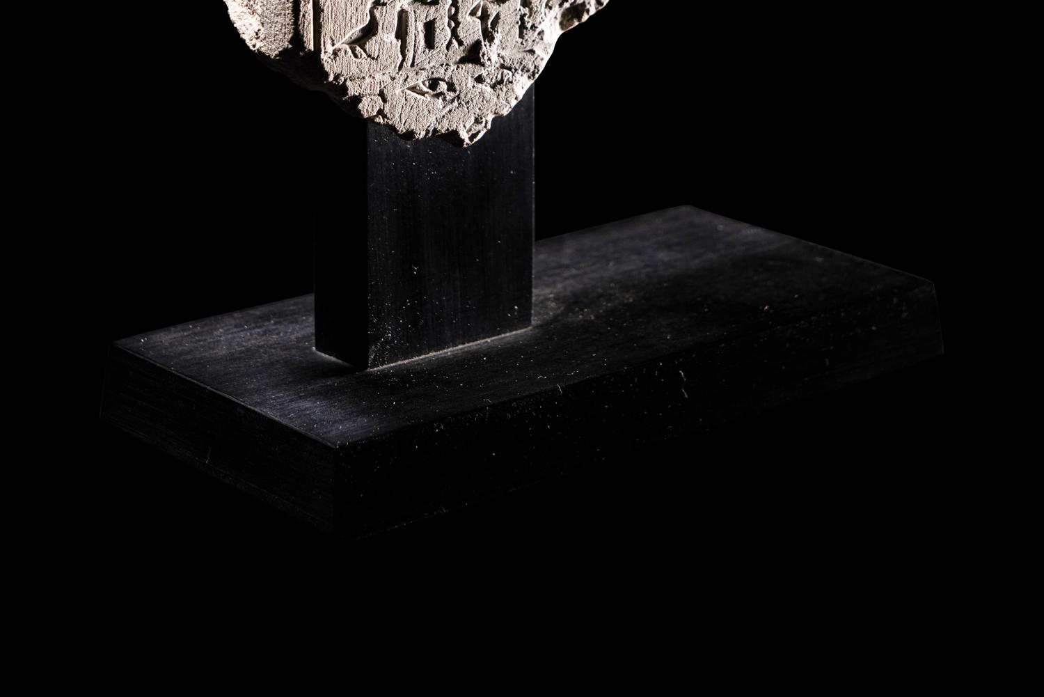 An Egyptian Limestone Round-Topped Stele