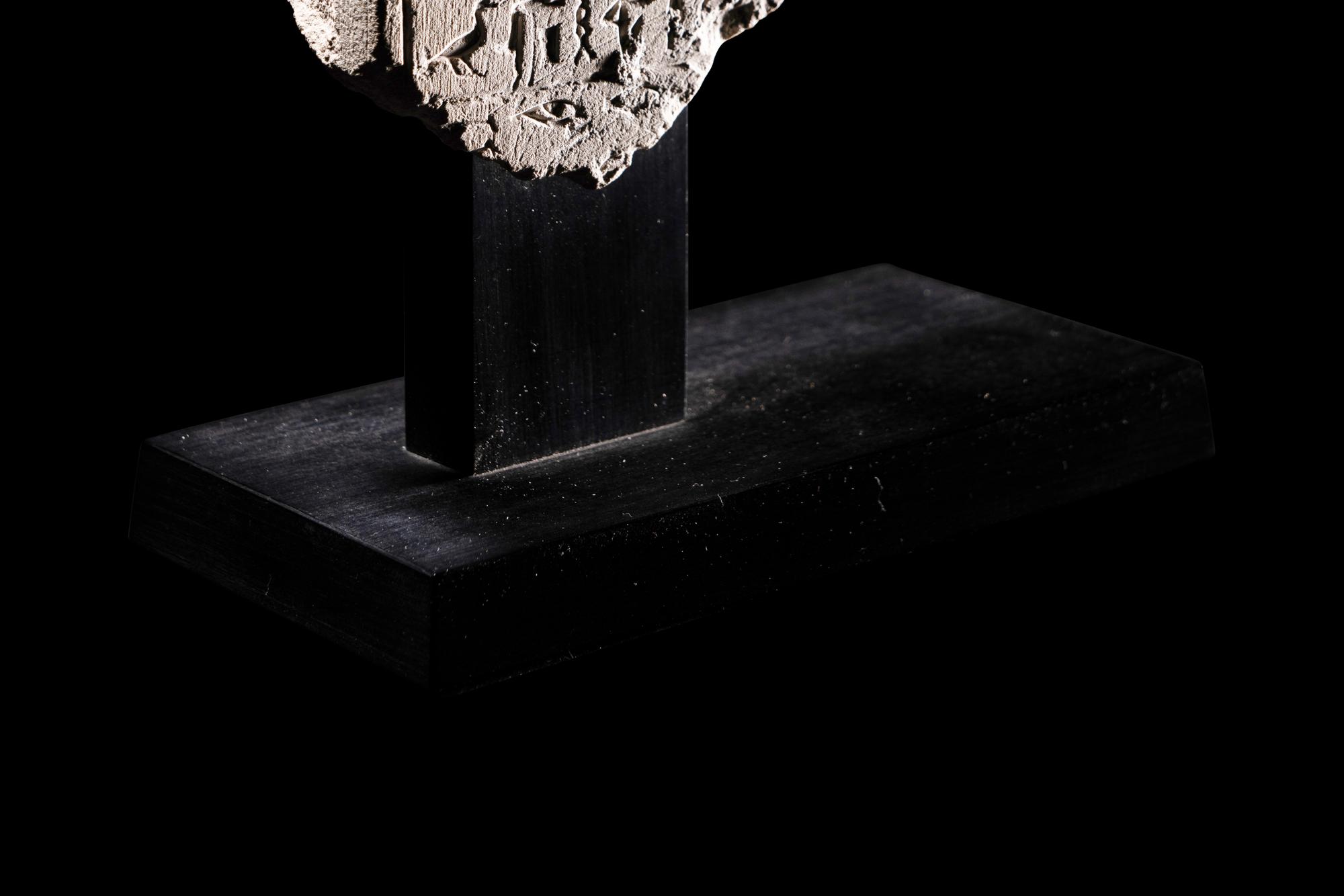 An Egyptian Limestone Round-Topped Stele