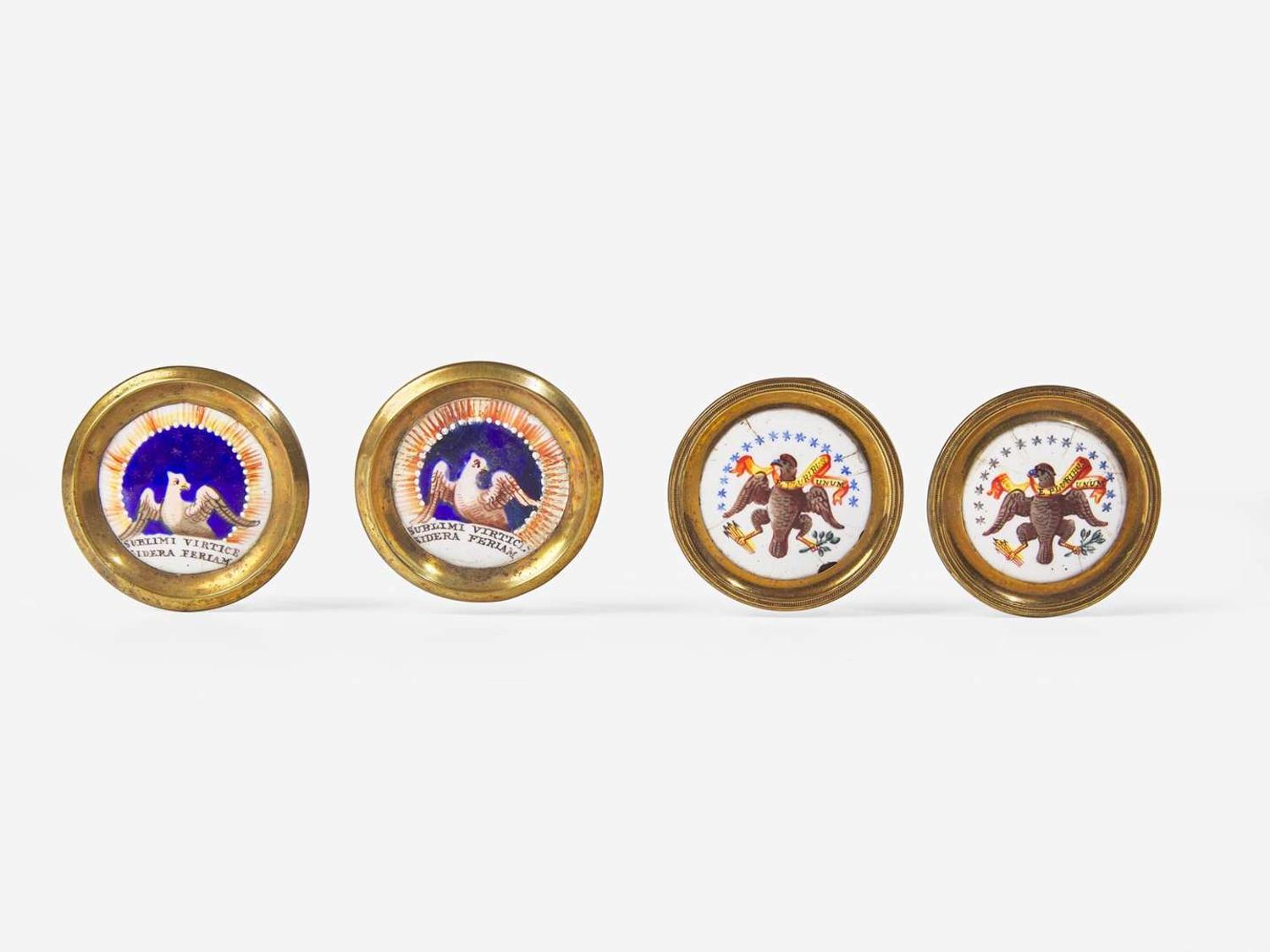 Four polychrome enameled porcelain and brass cloak pins or mirror supports with an American eagle and motto, England, early 19th century