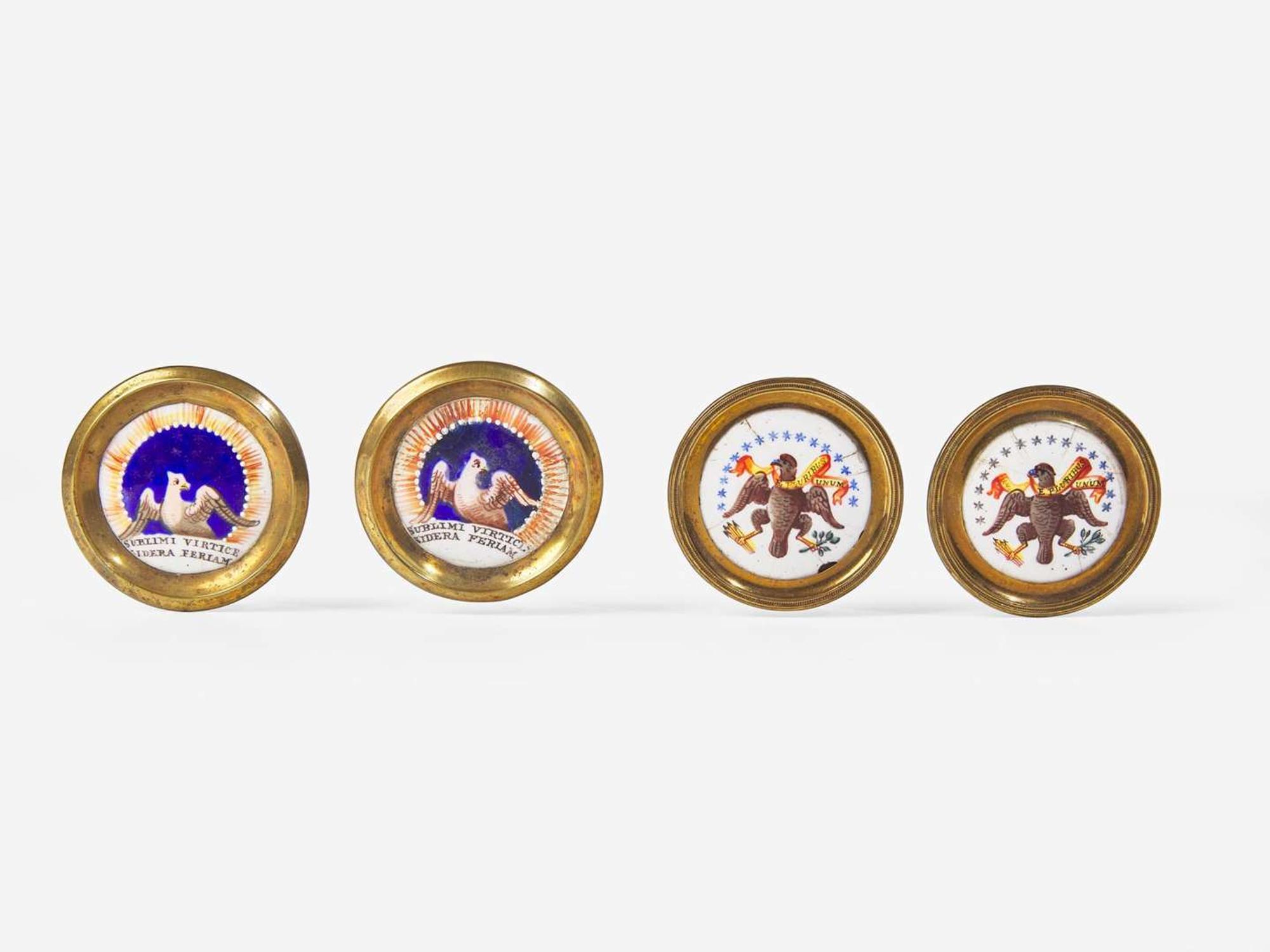 Four polychrome enameled porcelain and brass cloak pins or mirror supports with an American eagle and motto, England, early 19th century