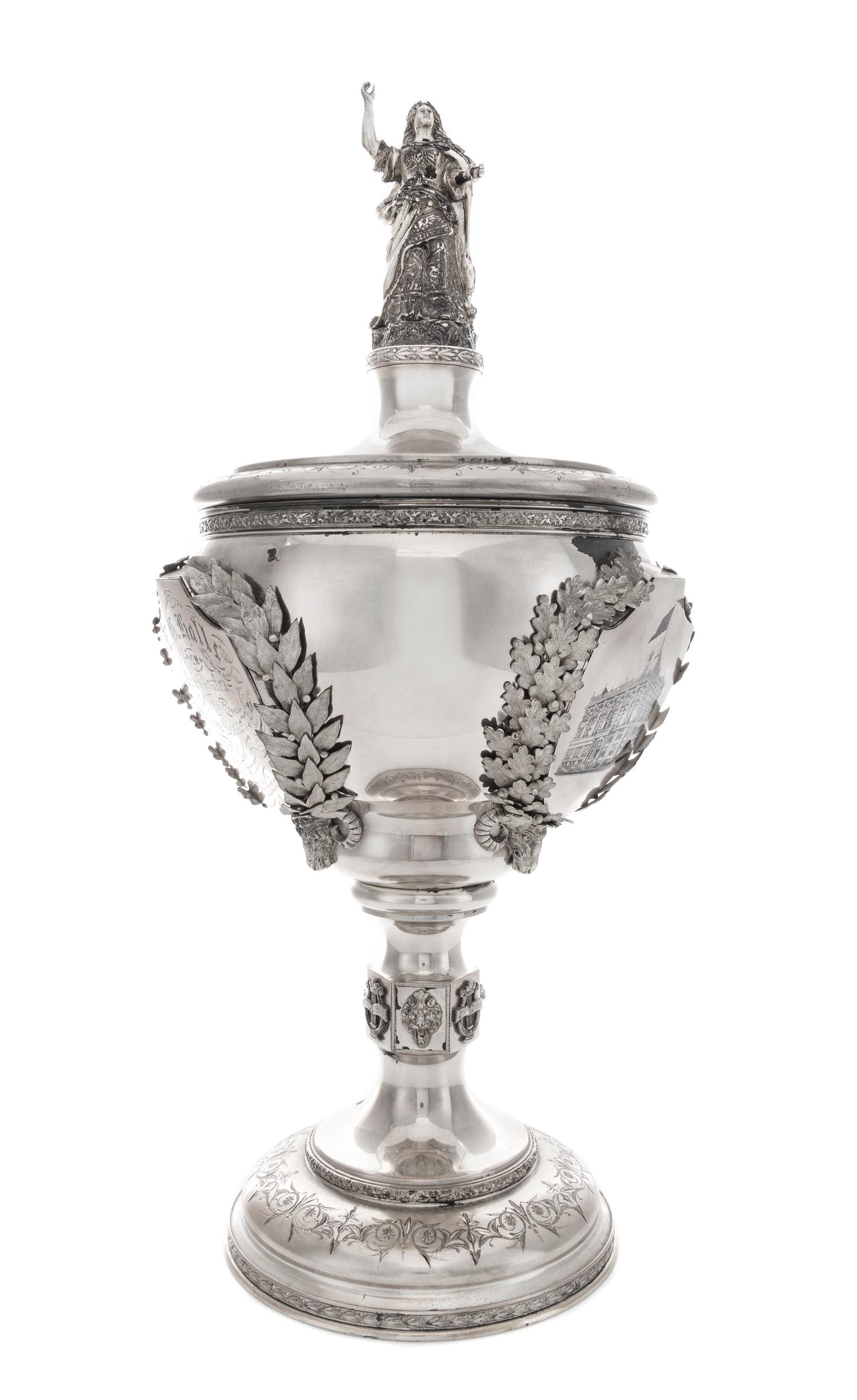 An American Silver Covered Trophy, Juergens & Andersen, Chicago, IL, Late 19th Century, of baluster form with a figural finial, the bod