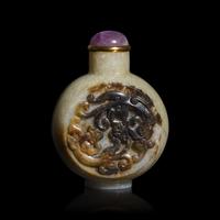 A Chinese Carved Beige and Brown Jade "Chilong" Snuff Bottle
