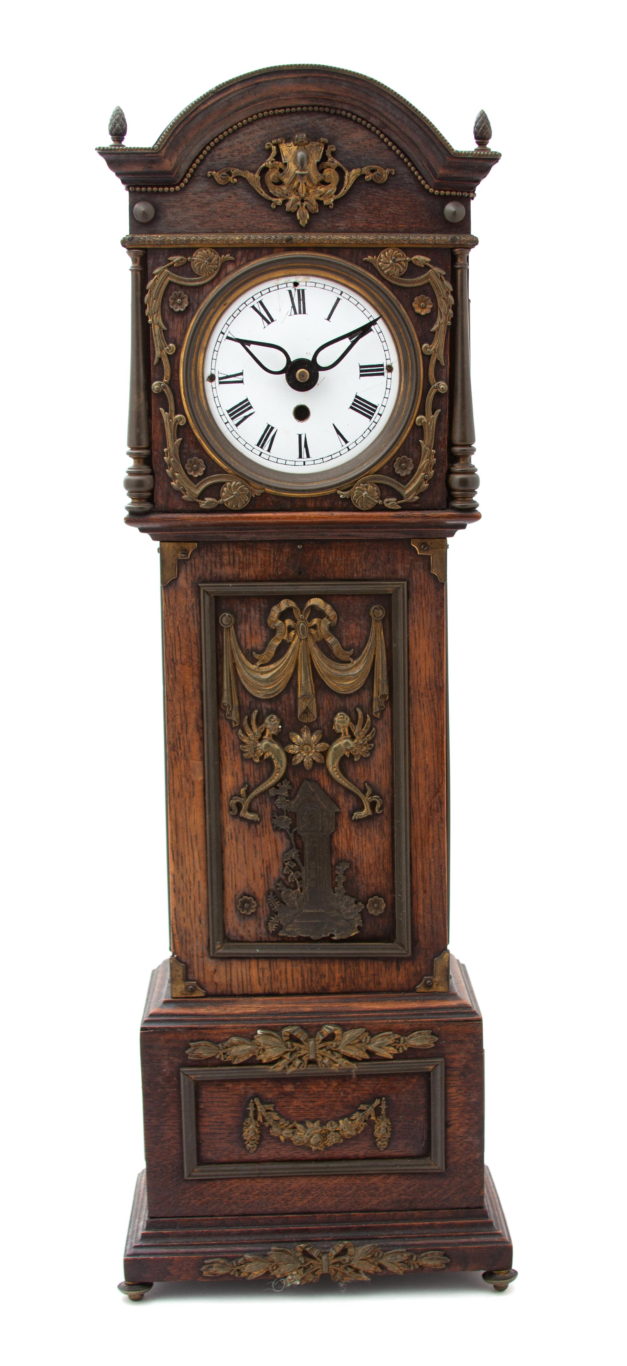 A Gilt Bronze Mounted Oak Miniature Tall Case Clock Height 23 1/2 x width 8 x 4 3/4 inches. — 19TH CENTURY