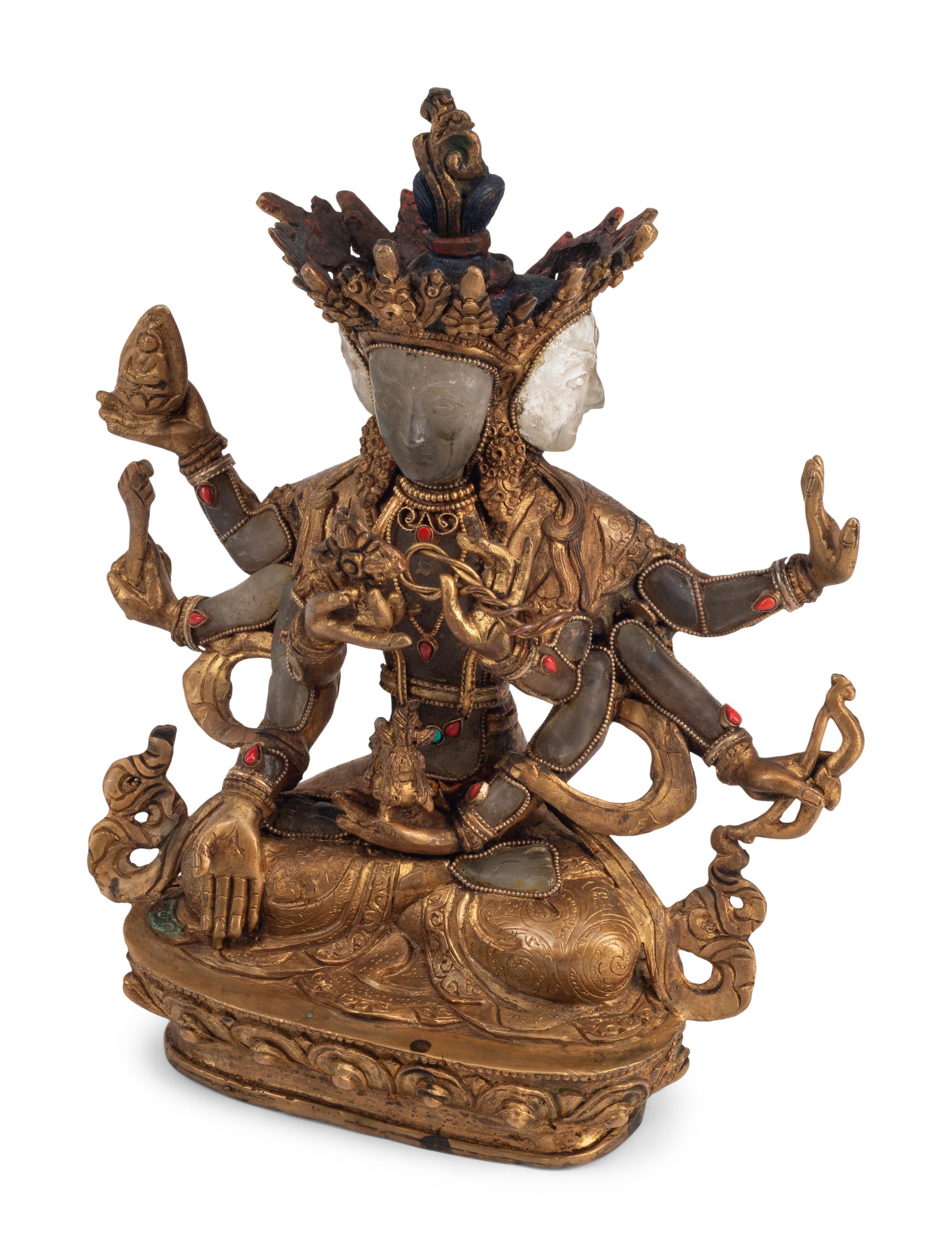 A Tibetan Style Gilt Bronze, Rock Crystal and Cabochon-Inset Figure of a Deity