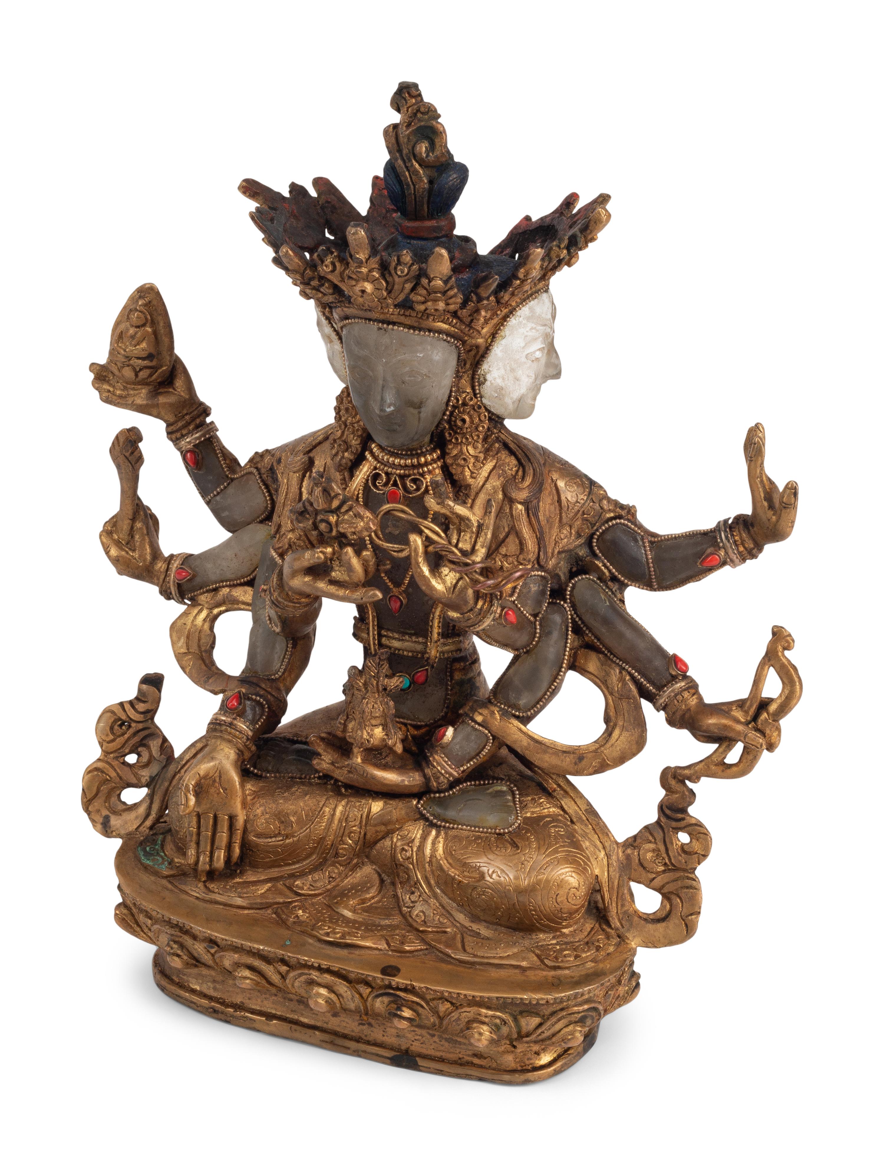 A Tibetan Style Gilt Bronze, Rock Crystal and Cabochon-Inset Figure of a Deity