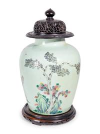 A Chinese Export Famille Rose Porcelain Jar and Carved Wood Cover