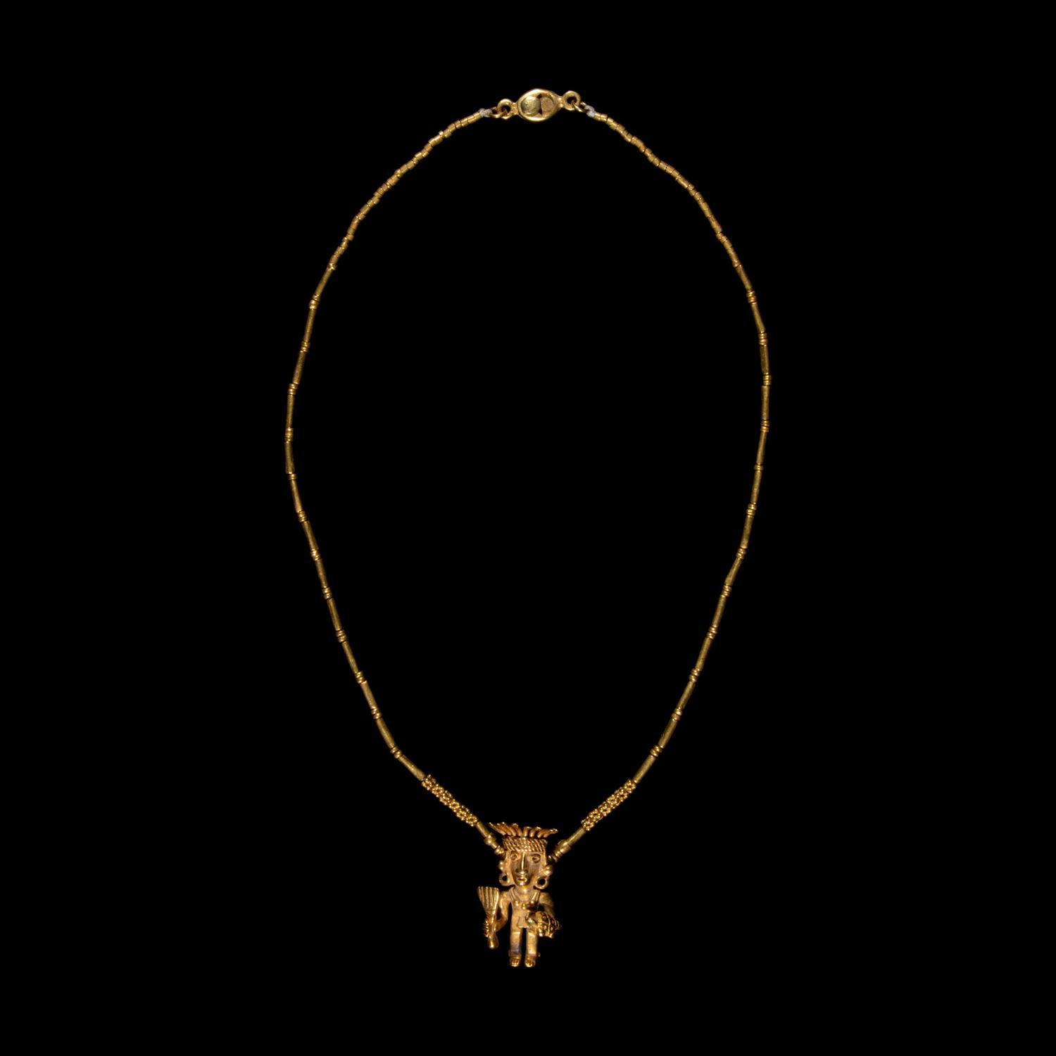 A Costa Rican Tumbaga Figural Pendant — with a gold chain