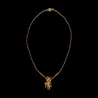 A Costa Rican Tumbaga Figural Pendant — with a gold chain