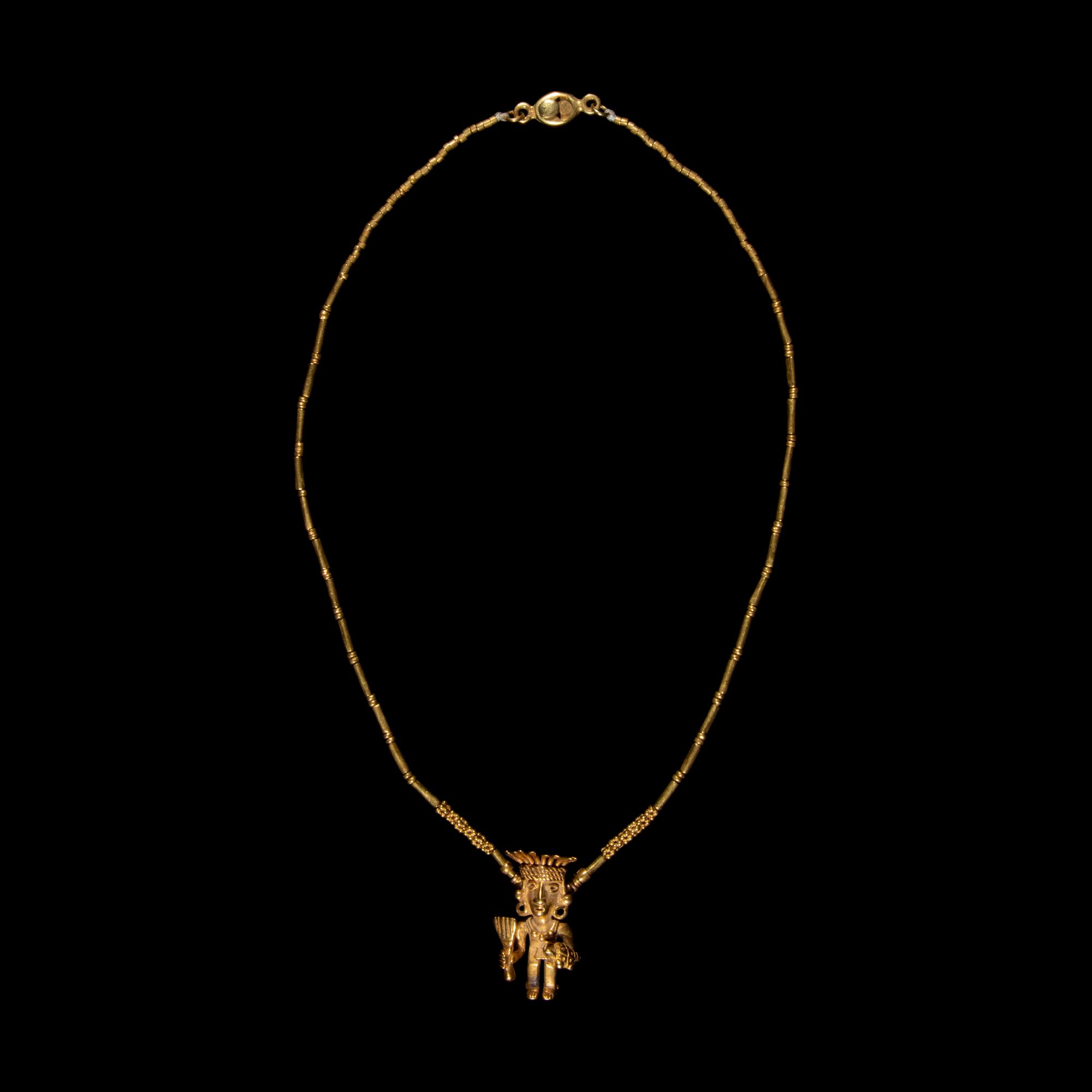A Costa Rican Tumbaga Figural Pendant — with a gold chain