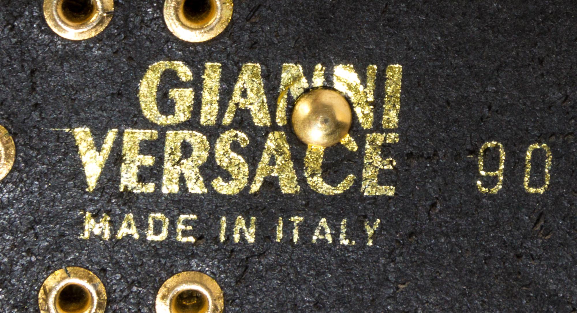 A Gianni Versace Limited Edition Black Leather Cross Belt, Belt width: 1.5"; Pin length: 6".