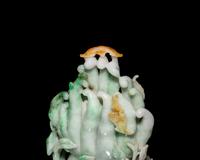 A Chinese Apple Green and Russet Jadeite Carving of Buddha's Hand Citron