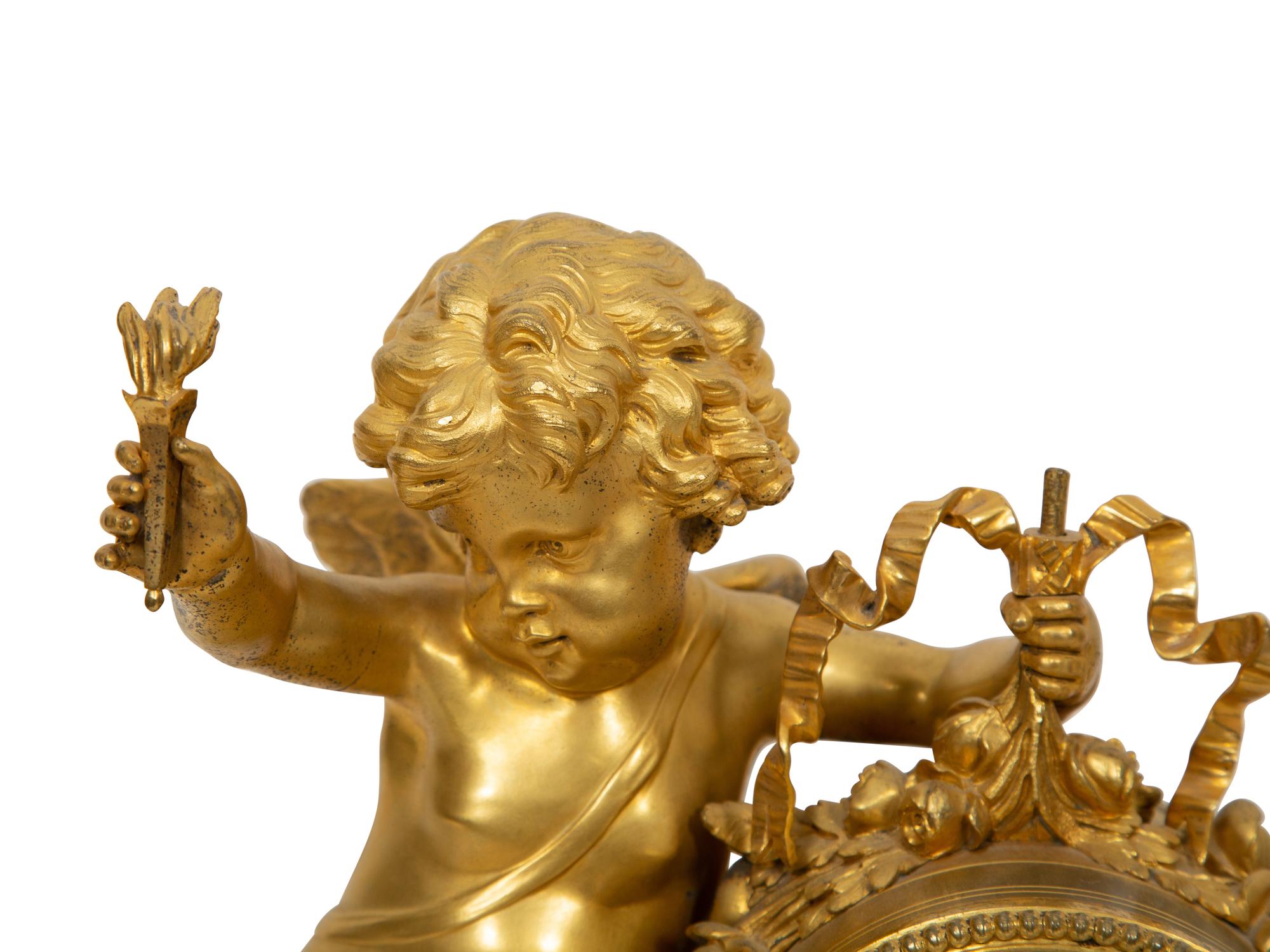 A Louis XVI Style Gilt Bronze and White Marble Mantel Clock