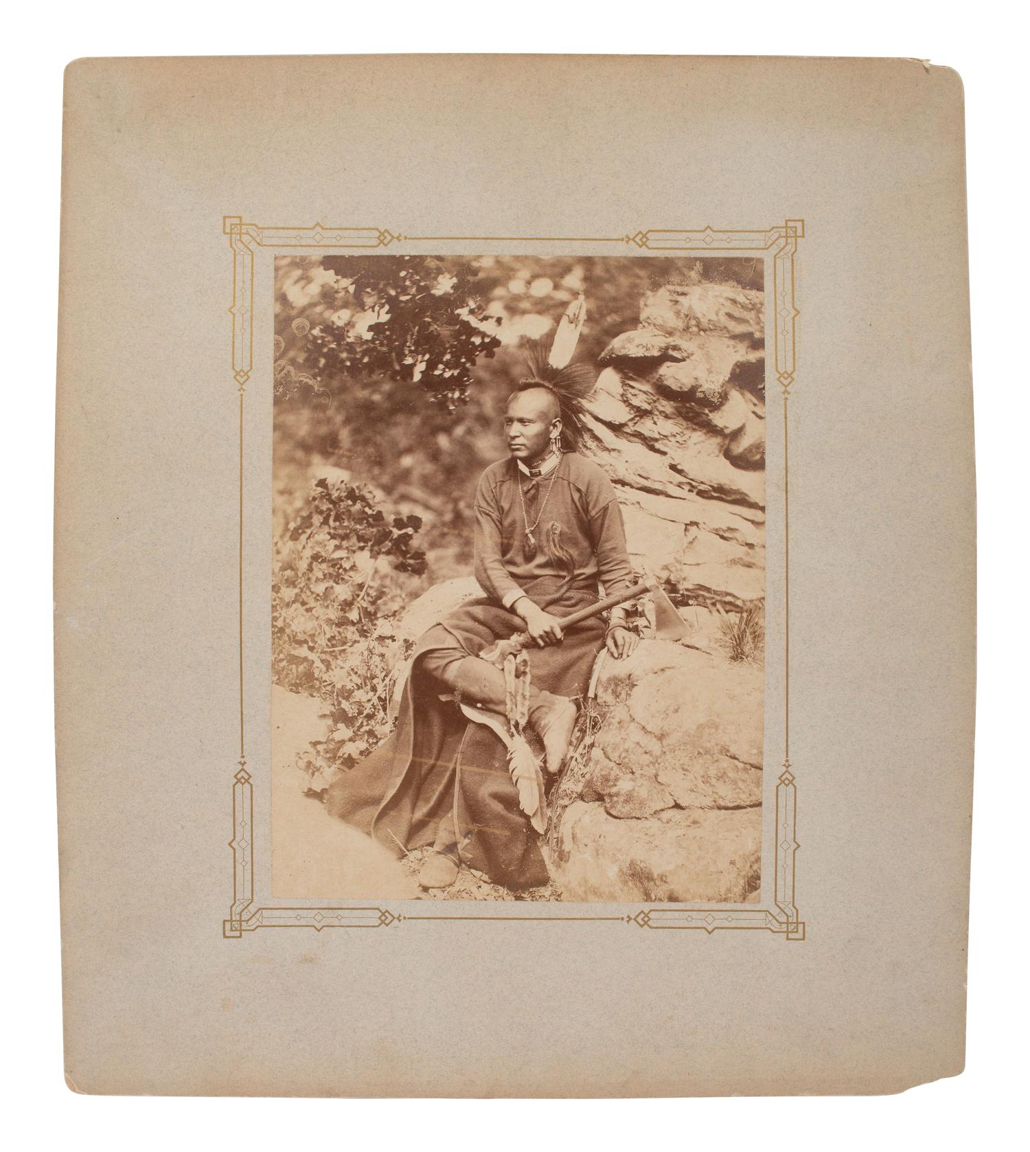 HILLERS, John K. (1843-1925), photographer. Photograph of an Osage warrior holding a tomahawk. Okmulgee, Indian Territory, 1875.