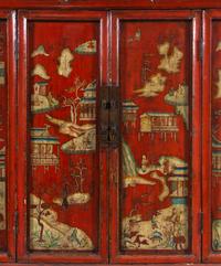 A Chinese Red Lacquered and Chinoiserie Decorated Armoire
