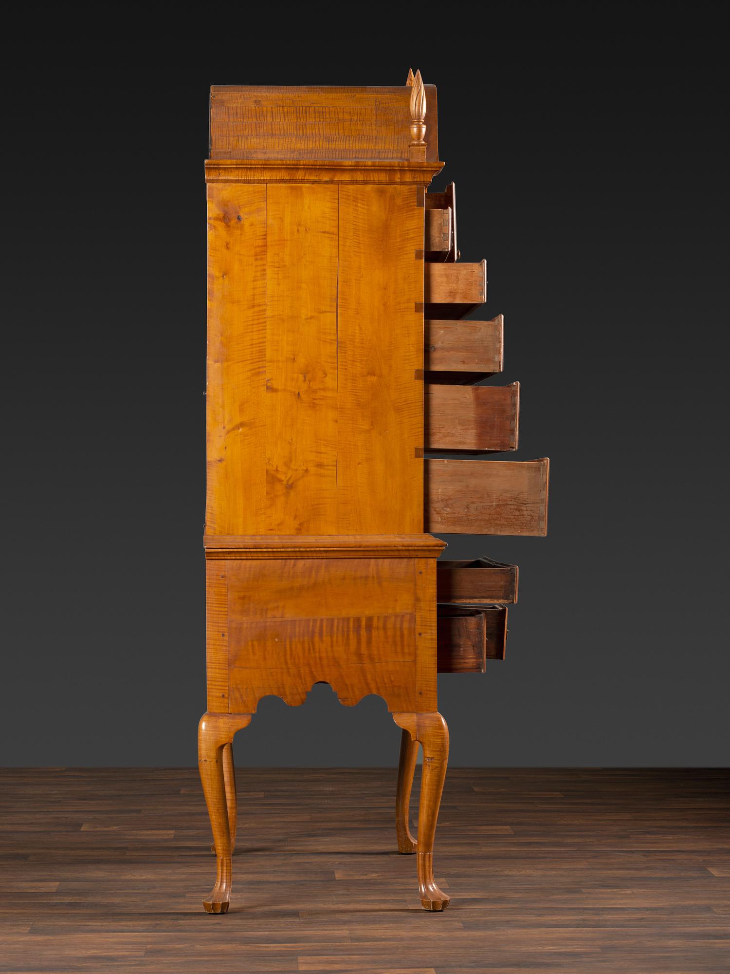 A Queen Anne Fan-Carved Tiger Maple Bonnet-Top Tablet-Foot High Chest