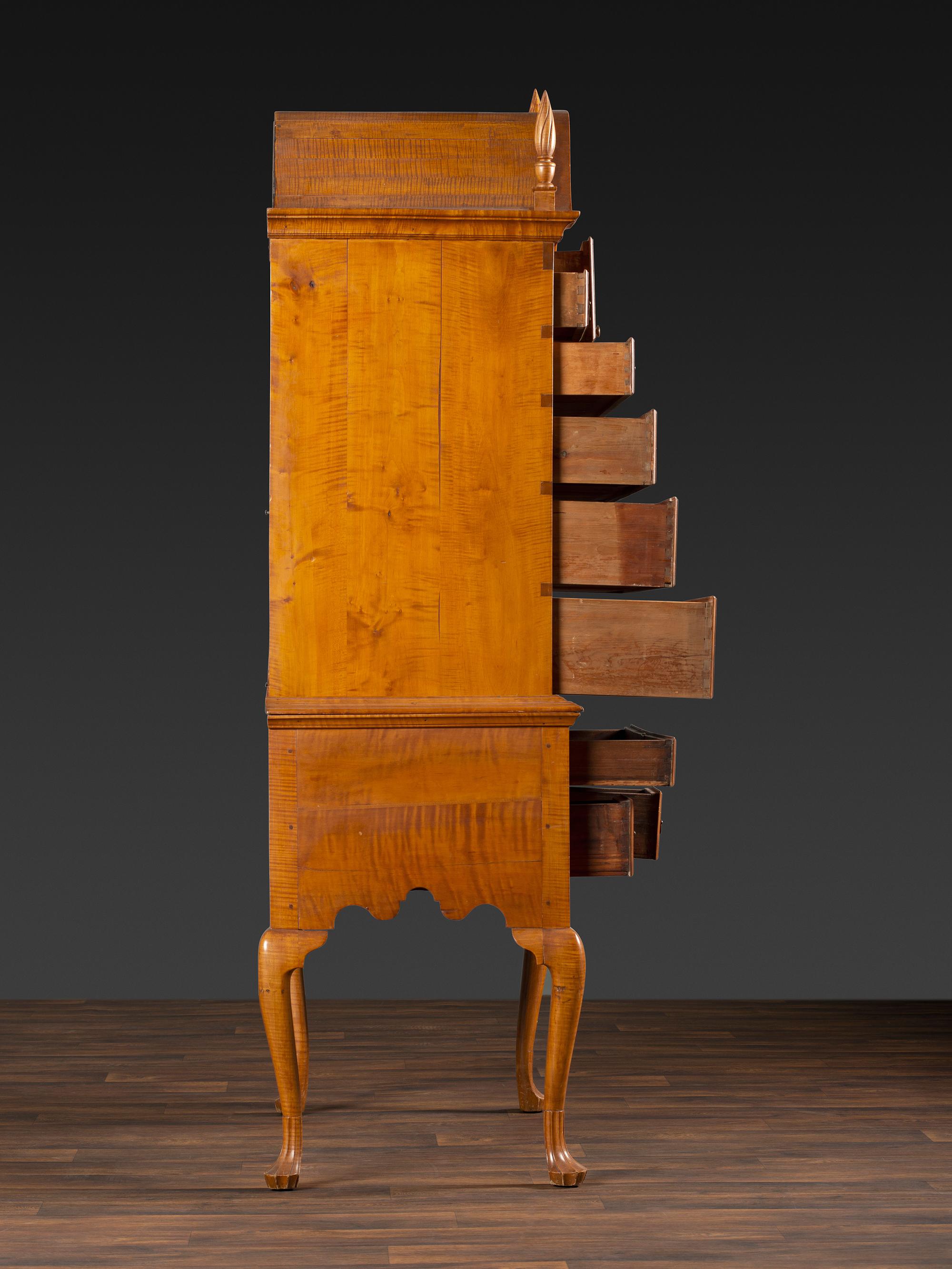 A Queen Anne Fan-Carved Tiger Maple Bonnet-Top Tablet-Foot High Chest