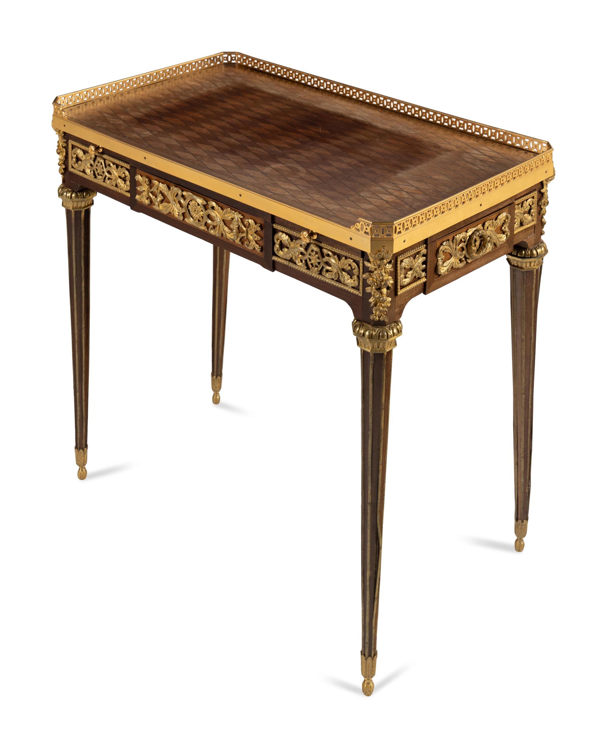 A Louis XVI Style Gilt Bronze Mounted Mahogany and Parquetry Table