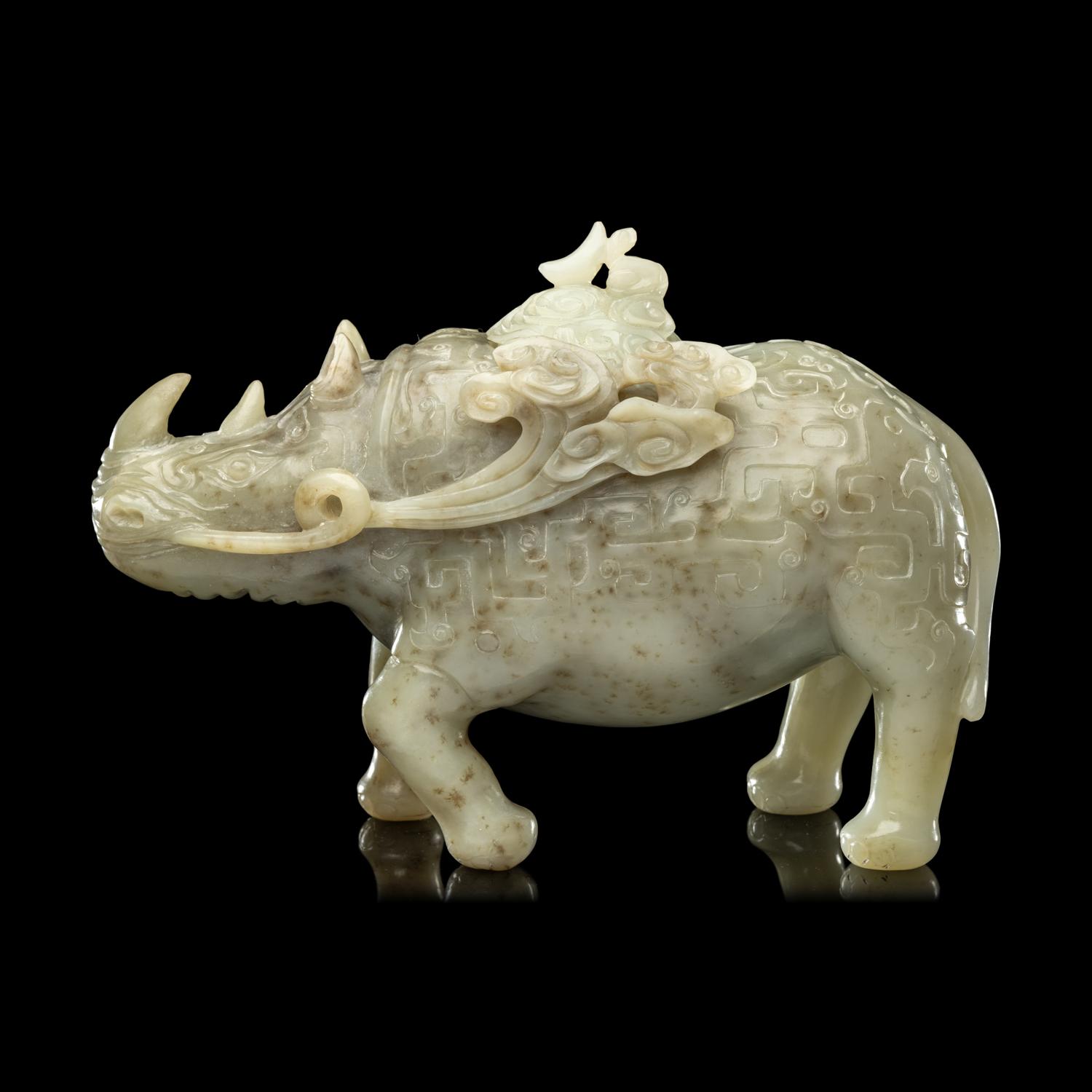 A Chinese Carved Celadon Jade Archaistic Rhinoceros-Form Covered Vessel, 20th Century 近代 青玉仿古犀尊